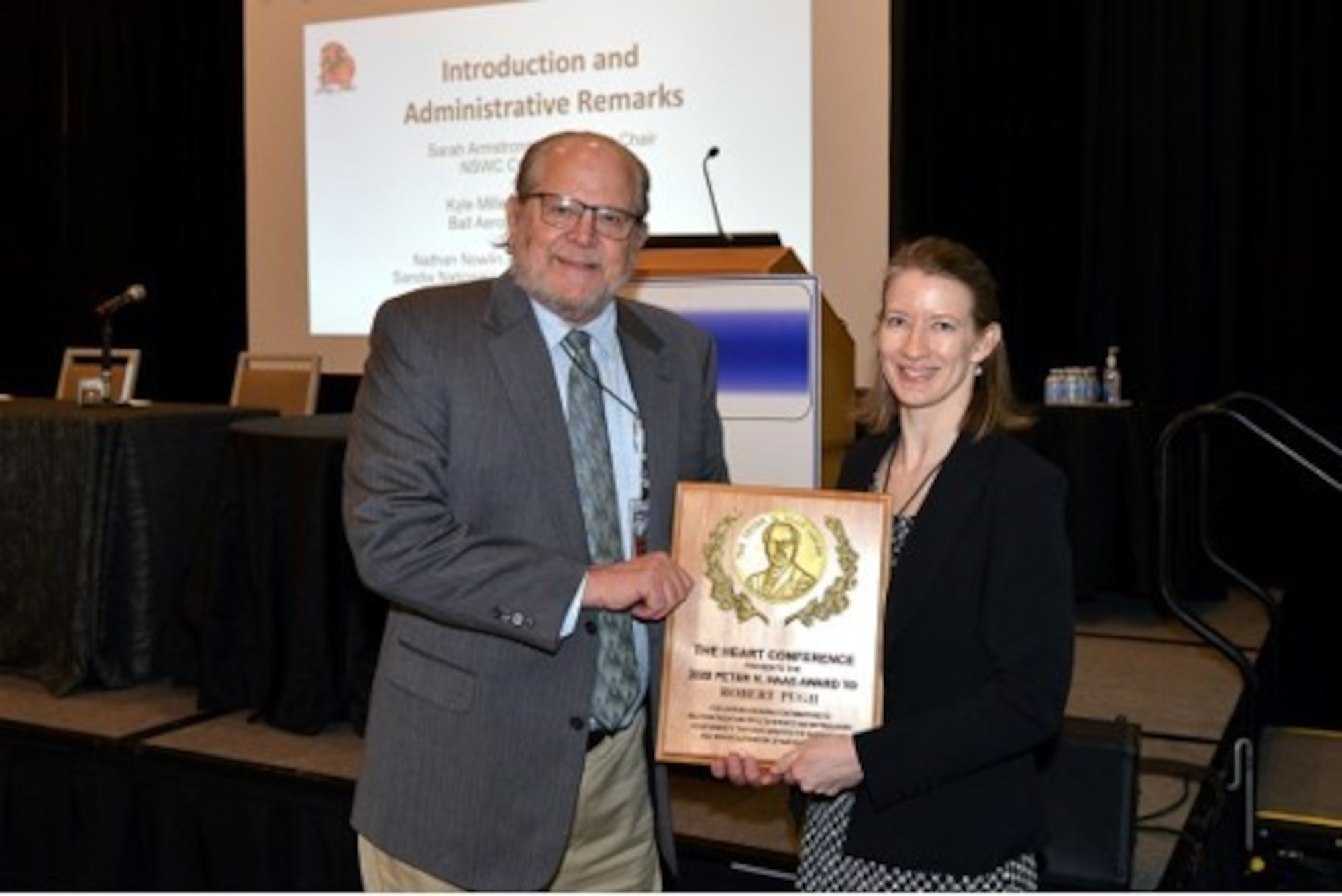 Dr. Robert Pugh receives the 2022 Peter Haas Hardened Electronics and Radiation Technology award for superior achievement from Dr. Sarah Armstrong, the President of the HEART Society, at the 2022 HEART Conference held in March at Tarrytown, New York. (Courtesy photo)