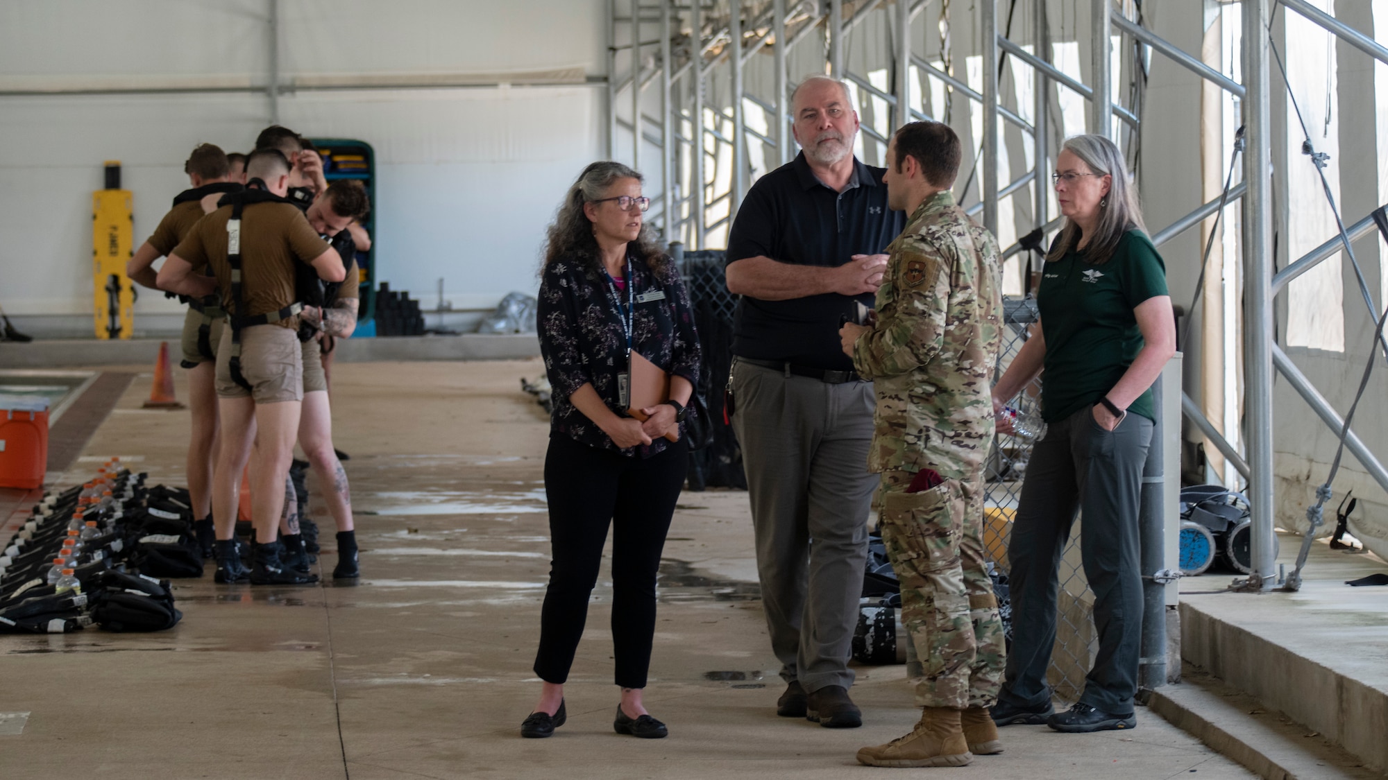 Dr. Wendy Walsh (near center), Air Education and Training Command chief learning officer, and Dr. Brian Davis (third from right), Second Air Force chief training officer, observe the Special Warfare Training Wing Pre-Dive Course with Maj. Kevin Epstein (second from right), 350th Special Warfare Training Squadron commander, and Dr. Karal Garcia (far right), Special Warfare Training Group training advisor, at Chaparral Pool on Joint Base San Antonio-Lackland, Texas, April 5, 2022. Walsh and her team participated in an immersion tour of the SWTW to learn about how the SWTW builds Air Force Special Warfare Airmen and prepares them for combat.