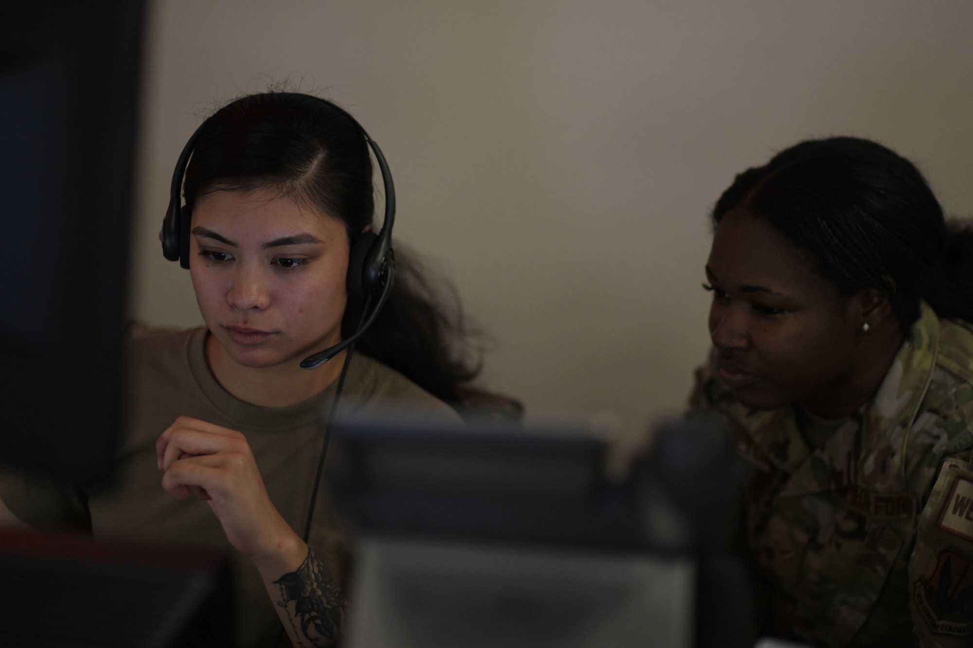 U.S. Air Force Senior Airman Anjeanette Florendo, left, and Airman 1st Class Mykisha Hamilton, right, 81st Air Control Squadron live technicians, monitor aircraft movement at Tyndall Air Force Base, Florida, March 29, 2022.
