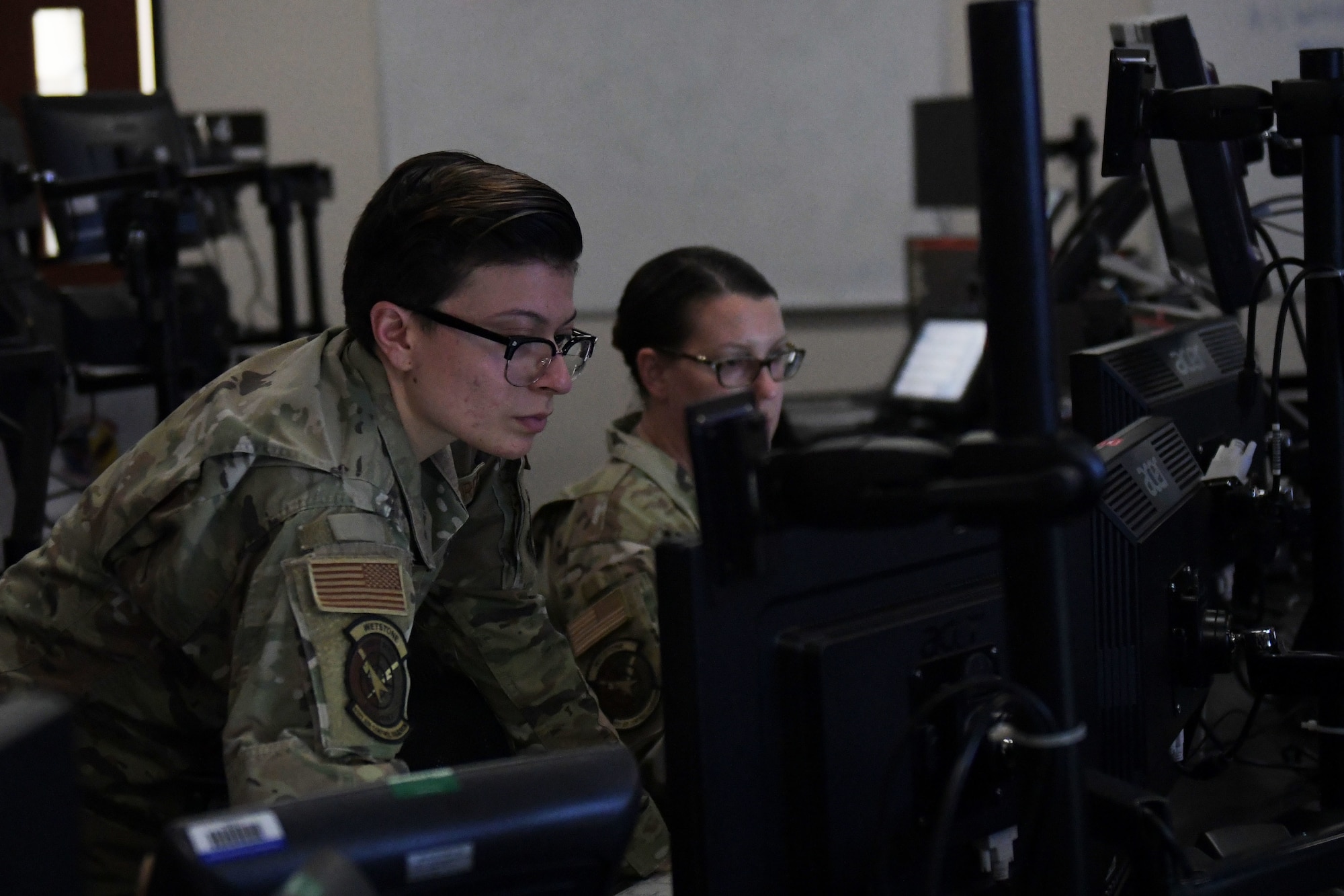 U.S. Air Force Senior Airman Megan Teran, left, 81st Air Control Squadron weapons director, and Master Sgt. Stephanie Leal, right, 81st ACS assistant operations superintendent, prepare for an exercise at Tyndall Air Force Base, Florida, March 29, 2022.