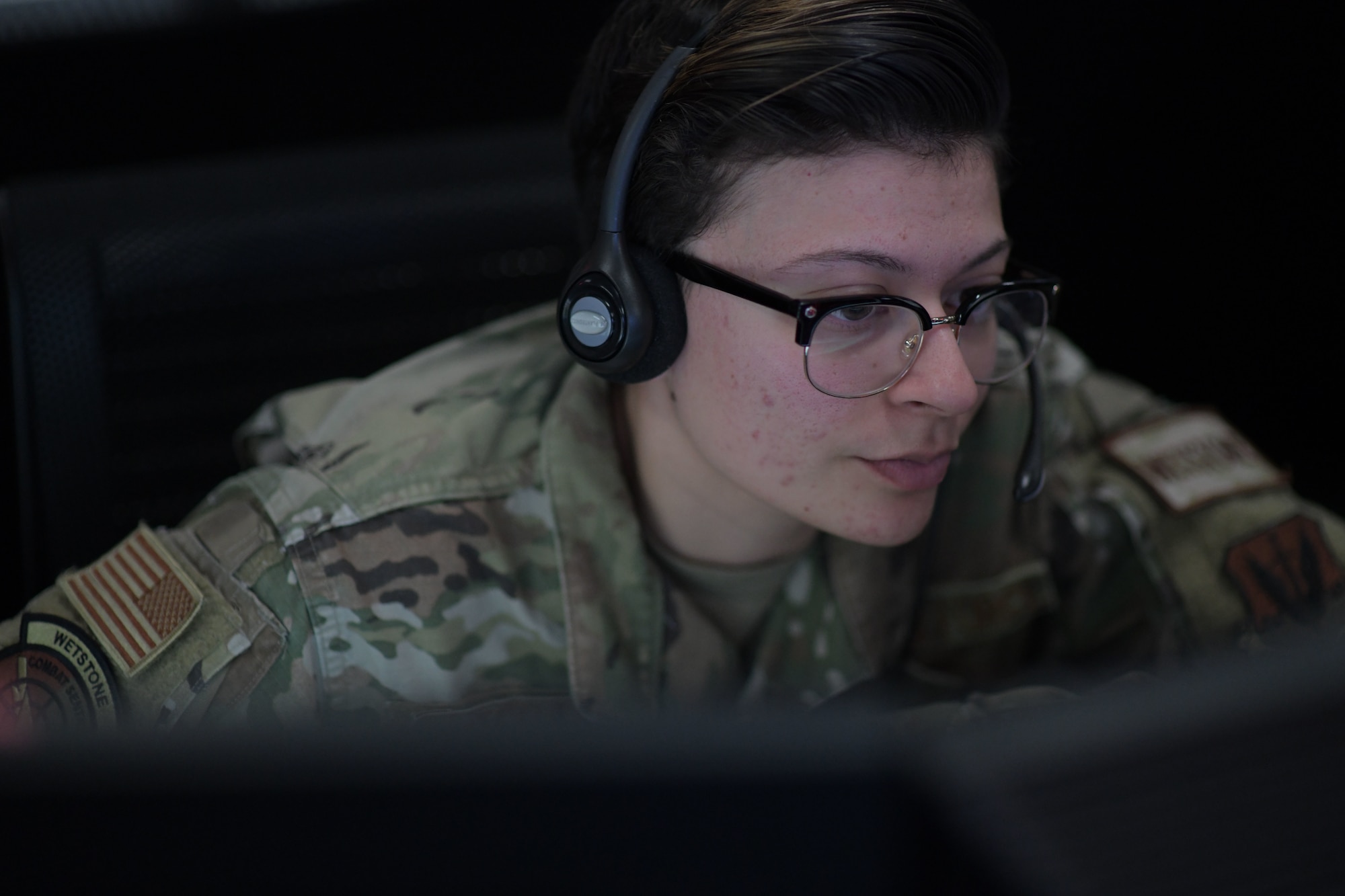 U.S. Air Force Senior Airman Megan Teran, left, 81st Air Control Squadron weapons director, informs pilots of potential threats via radio communication during Weapons System Evaluation Program East 22.06 at Tyndall Air Force Base, Florida, March 29, 2022.