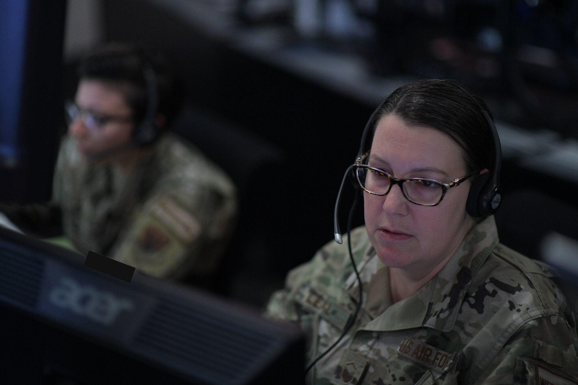 U.S. Air Force Master Sgt. Stephanie Leal, right, 81st ACS assistant operations superintendent, identifies aircraft at Tyndall Air Force Base, Florida, March 29, 2022.
