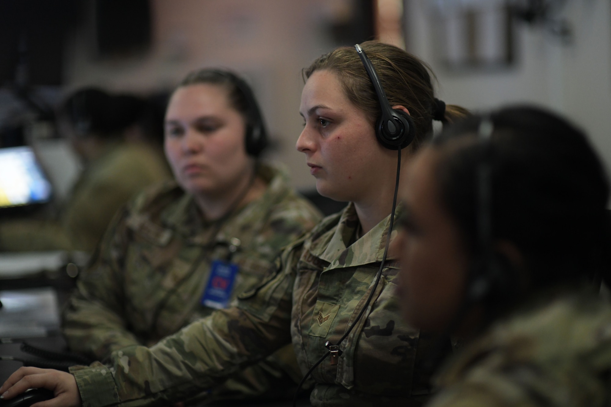 U.S. Air Force Senior Airman Rhiannon Padgett, center, 81st Air Control Squadron weapons director, explains the squadron’s role to two Airmen from the 325th Operations Support Squadron intel office at Tyndall Air Force Base, Florida, March 29, 2022.
