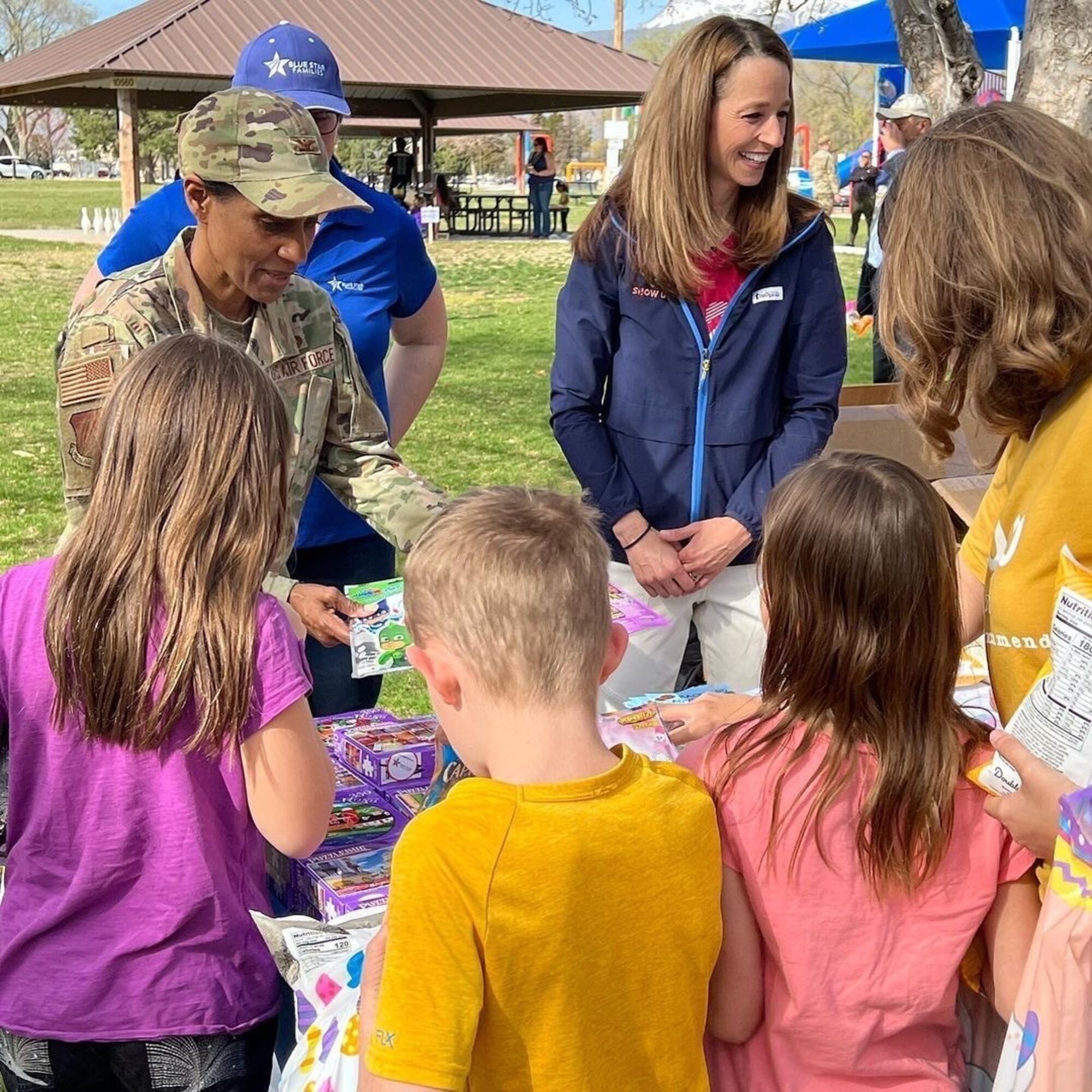 Col. Jenise Carroll, 75th Air Base Wing commander, and Utah First Lady Abby Cox give out gift bags