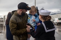 A Sailor reunites with her family after Arleigh Burke-class guided-missile destroyer USS McCampbell (DDG 85) arrived to its new homeport of Naval Station Everett, Washington April 8, 2022. Prior to relocating, the ship underwent an extensive Depot Modernization Period in Portland, Oregon that spanned more than 18 months. The modernization included improvements to the hull, mechanical systems, electrical technology, wireless communications, and weapon upgrades. This routine maintenance ensures the ship can continue to be mission capable throughout its expected service life.