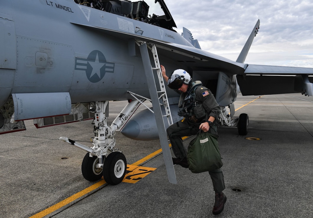 Lt. Cmdr. Mark Ramirez exits an EA-18G Growler following his first flight assigned to Electronic Attack Squadron (VAQ) 144 at Naval Air Station Whidbey Island in Oak Harbor, Washington October 4, 2021. Electronic attack squadrons operate from aircraft carriers and fixed land bases to tactically exploit, suppress, degrade and deceive enemy electromagnetic defensive and offensive systems, including communications and pro-forma signals in support of amphibious assaults, air strikes and fleet operations.