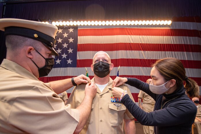 Chief Logistics Specialist Daniel Neal is pinned during a chief petty officer pinning ceremony at Naval Base Kitsap in Bremerton, Washington Nov. 19, 2021. The rank of chief petty officer was officially established April 1, 1893, and holding the title "Chief" means a Sailor has achieved senior non-commissioned officer status.