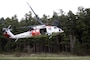 An MH-60 Seahawk helicopter assigned to Naval Air Station Whidbey Island's (NASWI) Search and Rescue (SAR) unit takes off from a training area near NASWI. The SAR team provides assistance to military and civilians throughout the Pacific Northwest.