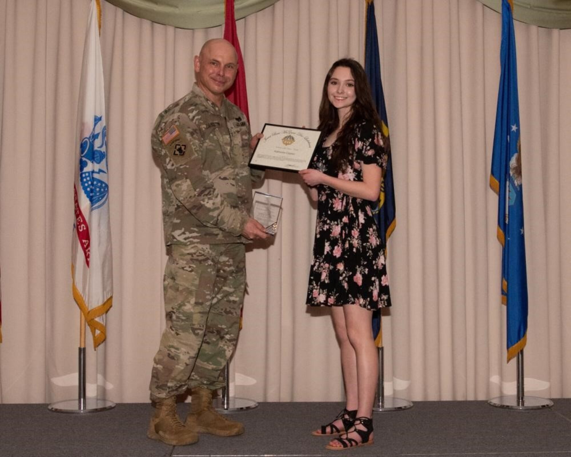 U.S. Army Col. Jon Brierton, Army Support Activitiy, Fort Dix Commander and Joint Base McGuire-Dix-Lakehurst, N.J., Deputy Commander, presents award to Katherine Clayton April 14, 2022 at Tommy B's Community Activities Center. Clayton was recognized as youth volunteer of the year.
