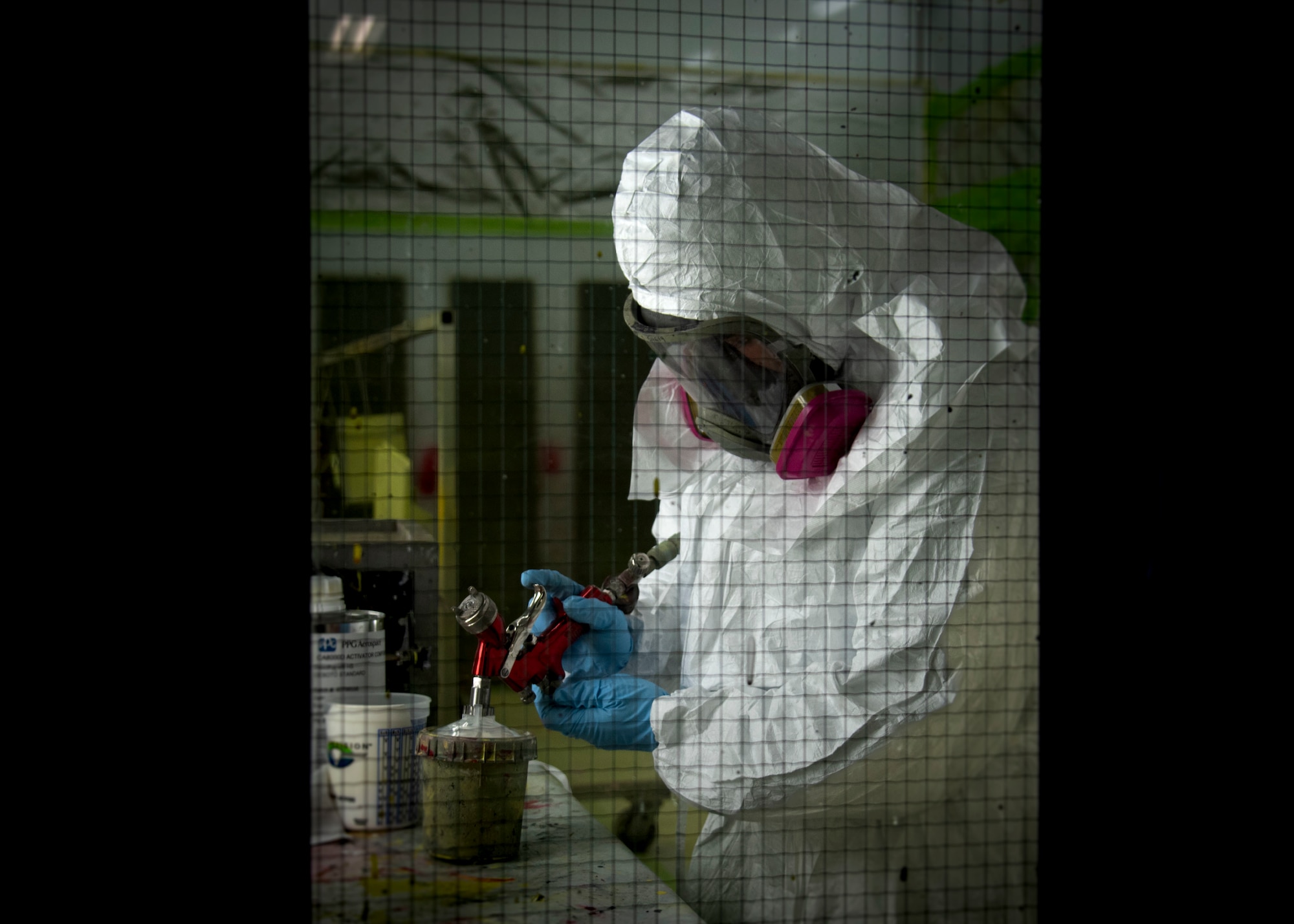 U.S. Air Force Senior Airman Raven Olivo, a 6th Maintenance Squadron aircraft structural maintenance apprentice, prepares a paint gun for use in the corrosion control facility at MacDill Air Force Base, Florida, April 12, 2022.