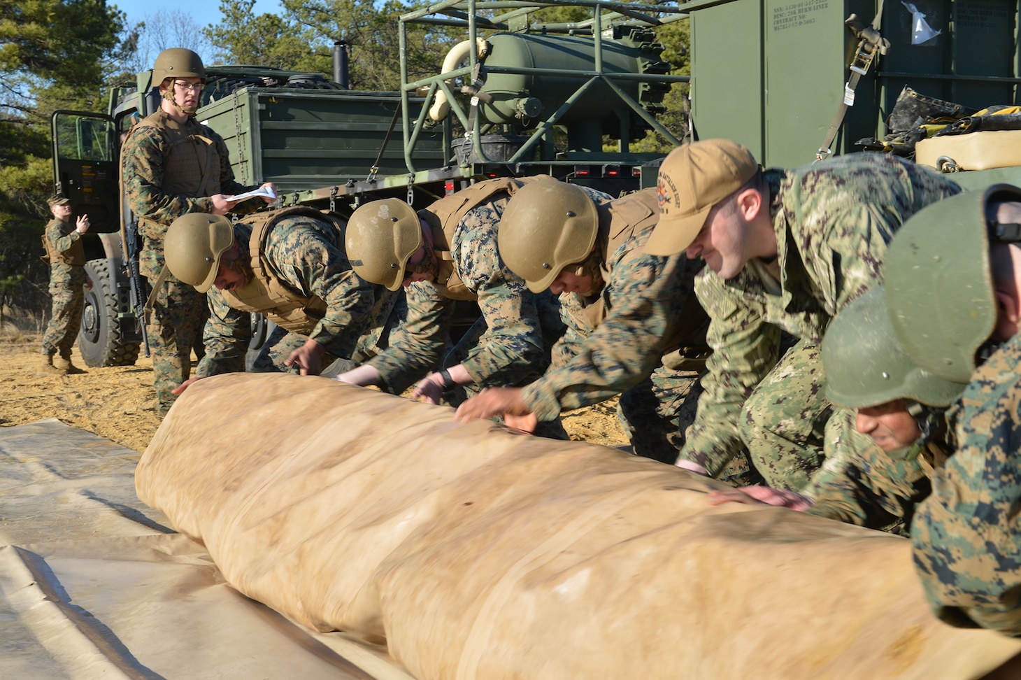 The blue-green teams of the Navy and Marine Corps expeditionary forces from Navy Cargo Handling Battalion EIGHT (NCHB-8) expeditionary fuels team and Marine Corps 6th Engineer Support Battalion Bulk Fuels Team, joined up at Joint Base McGuire-Dix-Lakehurst, New Jersey, to integrate and train in coordination to focus on a concept of employment experimentation with the Expeditionary Fuel Dispensing System–Small (EFDS-S).