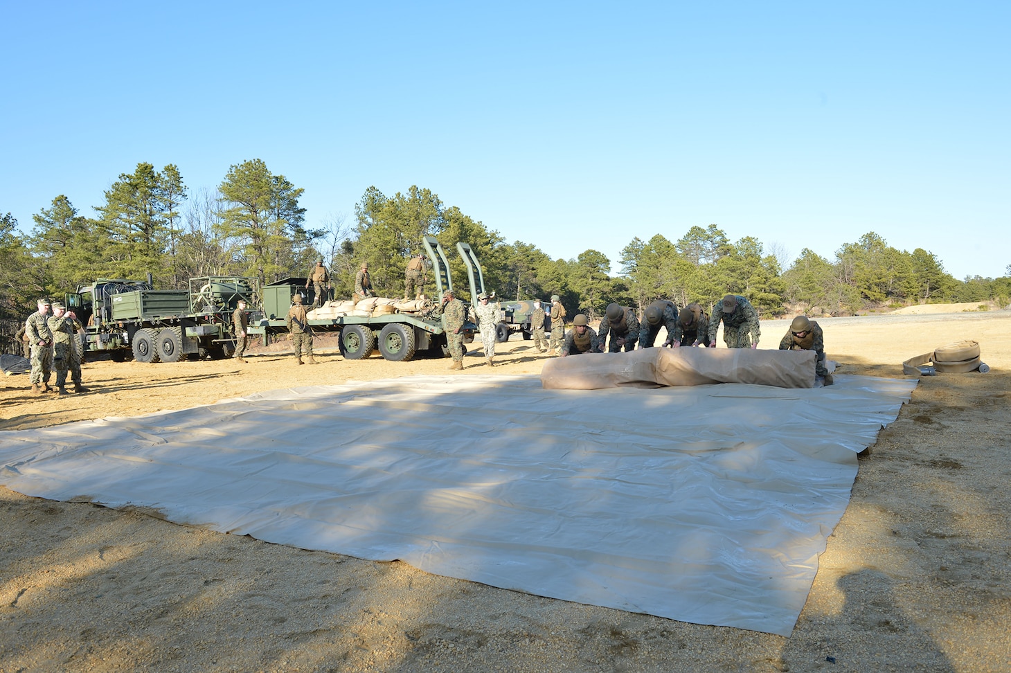 The blue-green teams of the Navy and Marine Corps expeditionary forces from Navy Cargo Handling Battalion EIGHT (NCHB-8) expeditionary fuels team and Marine Corps 6th Engineer Support Battalion Bulk Fuels Team, joined up at Joint Base McGuire-Dix-Lakehurst, New Jersey, to integrate and train in coordination to focus on a concept of employment experimentation with the Expeditionary Fuel Dispensing System–Small (EFDS-S).