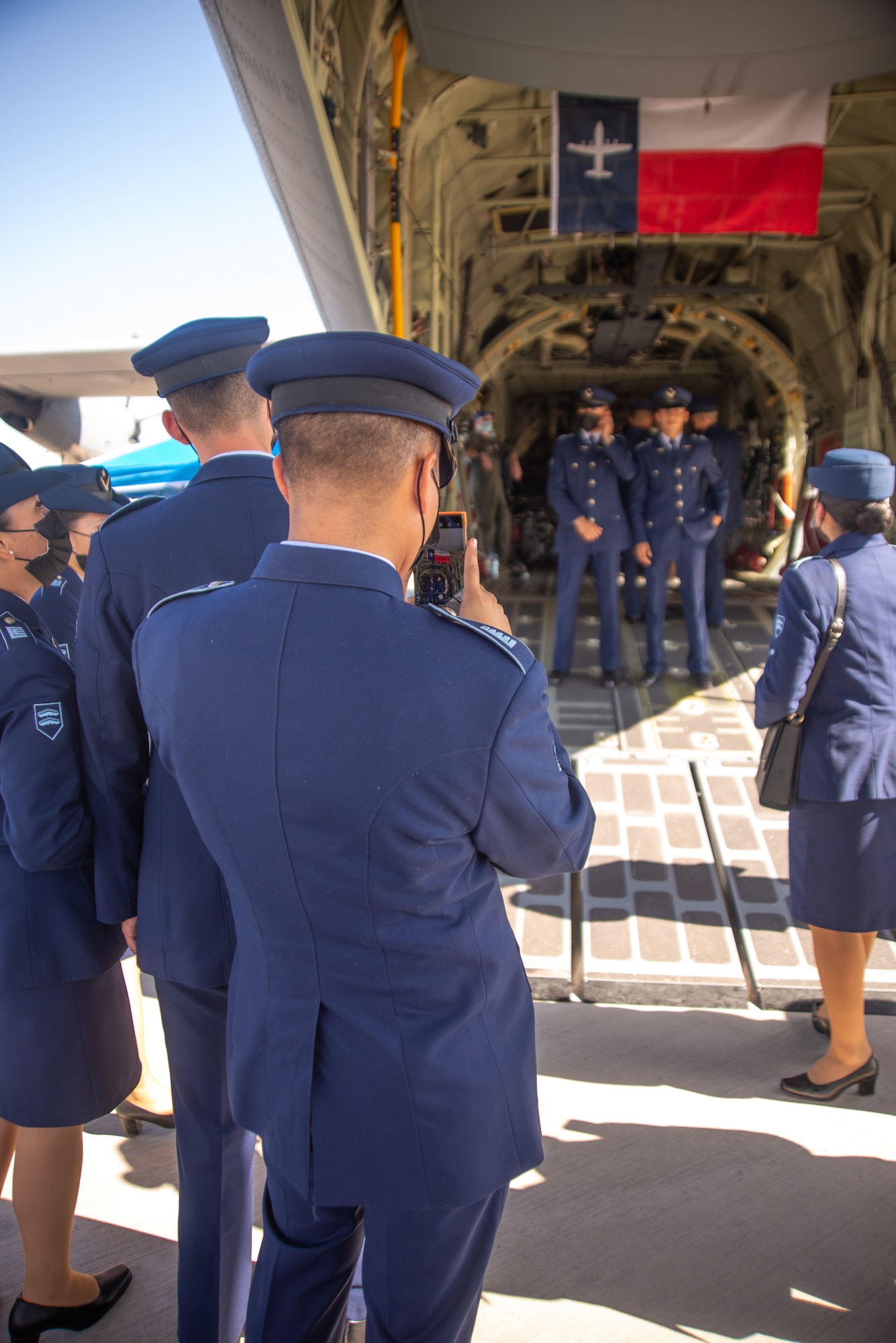 Chilean cadet photographs other cadets in a C-130J.