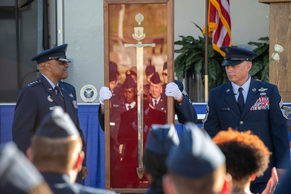 Enlisted Airmen of Air Education and Training Command induct Gen. Anthony J. Cotton, Commander, U.S. Air Force Global Strike Command and Commander, Air Forces Strategic-Air, U.S. Strategic Command, into the AETC Order of the Sword in a ceremony.