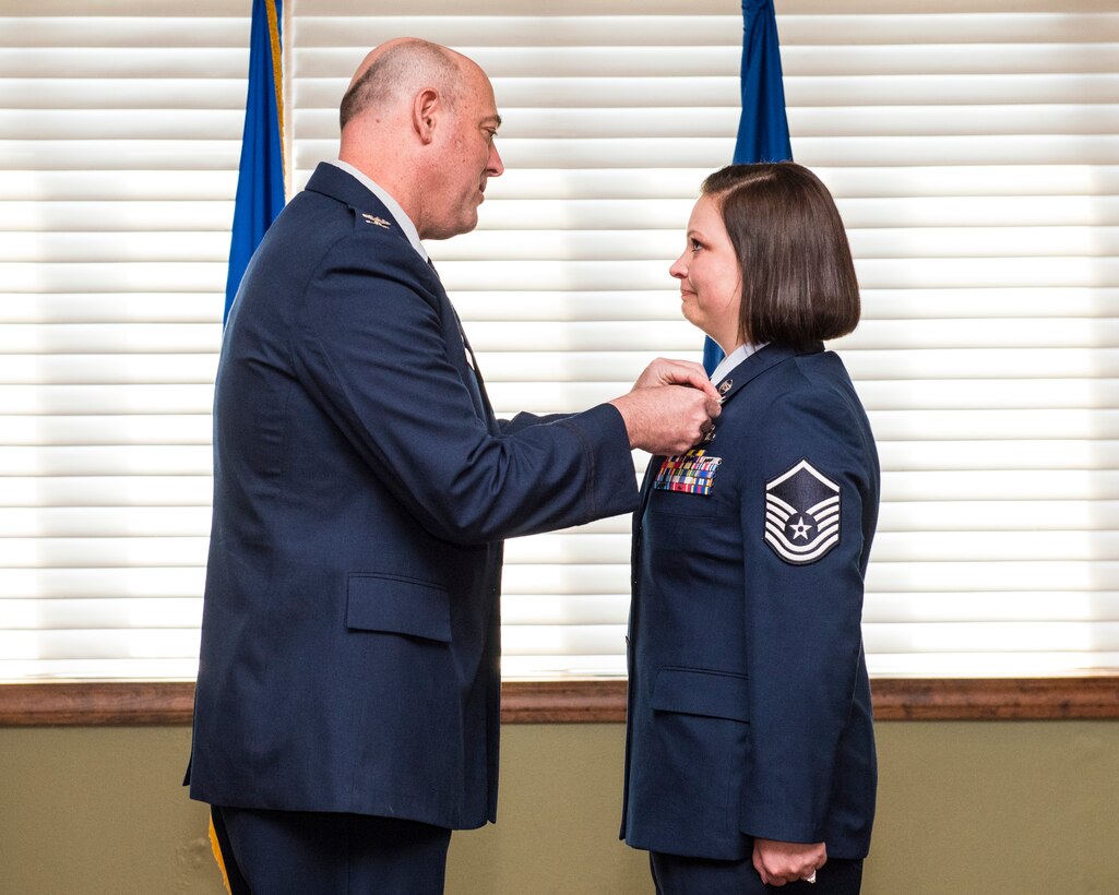 U.S. Air Force Col. Patrick Miller, 88th Air Base Wing and Installation commander, pins Master Sgt. Wendi DiBartolomeo with the Bronze Star Medal, April 15, 2022 at Wright-Patterson Air Force Base, Ohio. DiBartolomeo was awarded the Bronze Star for her actions during Operation Allies Refuge in Kabul, Afghanistan.