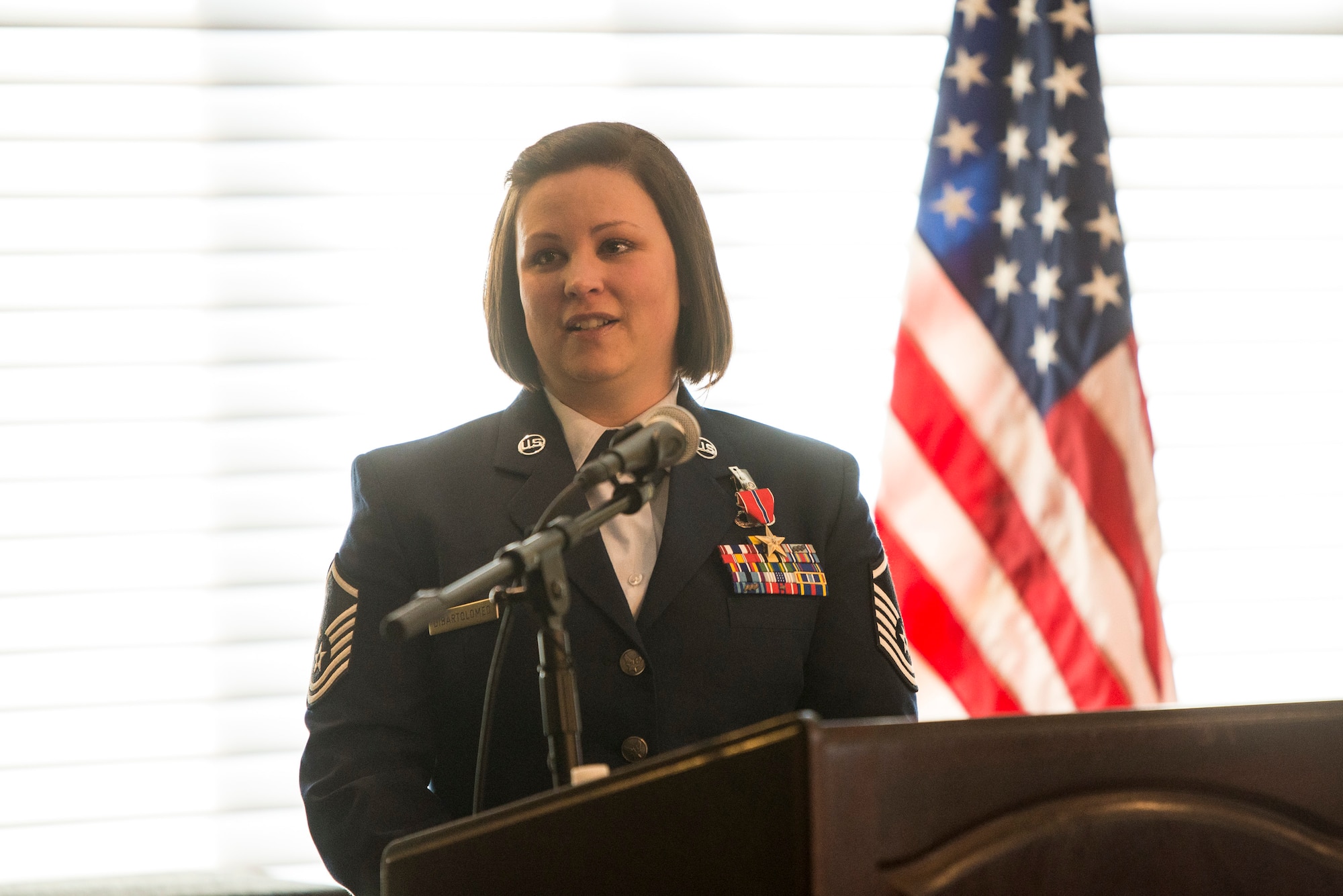 U.S. Air Force Master Sgt. Wendi DiBartolomeo speaks during a ceremony after being awarded the Bronze Star Medal, April 15, 2022 at Wright-Patterson Air Force Base, Ohio. DiBartolomeo was awarded the Bronze Star for her actions during Operation Allies Refuge in Kabul, Afghanistan.