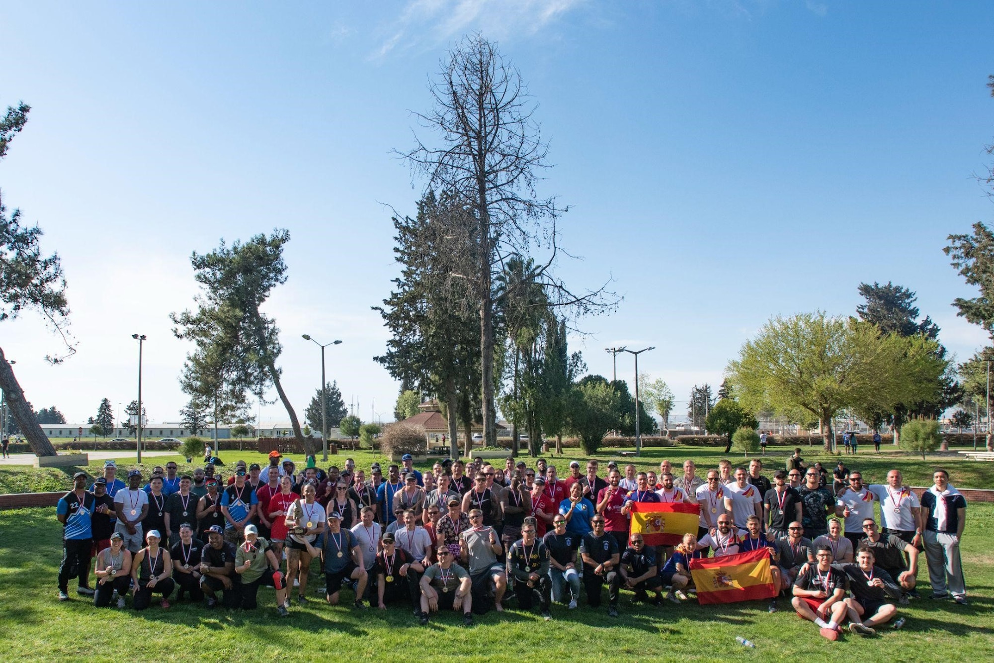 NATO allies and base community members gather for a group photo during wing sports day at Incirlik Air Base, Turkey, April 14, 2022. During the event, U.S. military members, civilians, Turkish local national employees and NATO allies competed in a series of athletic events and activities to kick off the spring season. This event was the first sports day that the 39th Air Base Wing hosted since 2013. (U.S. Air Force photo by Staff Sgt. Gabrielle Winn)