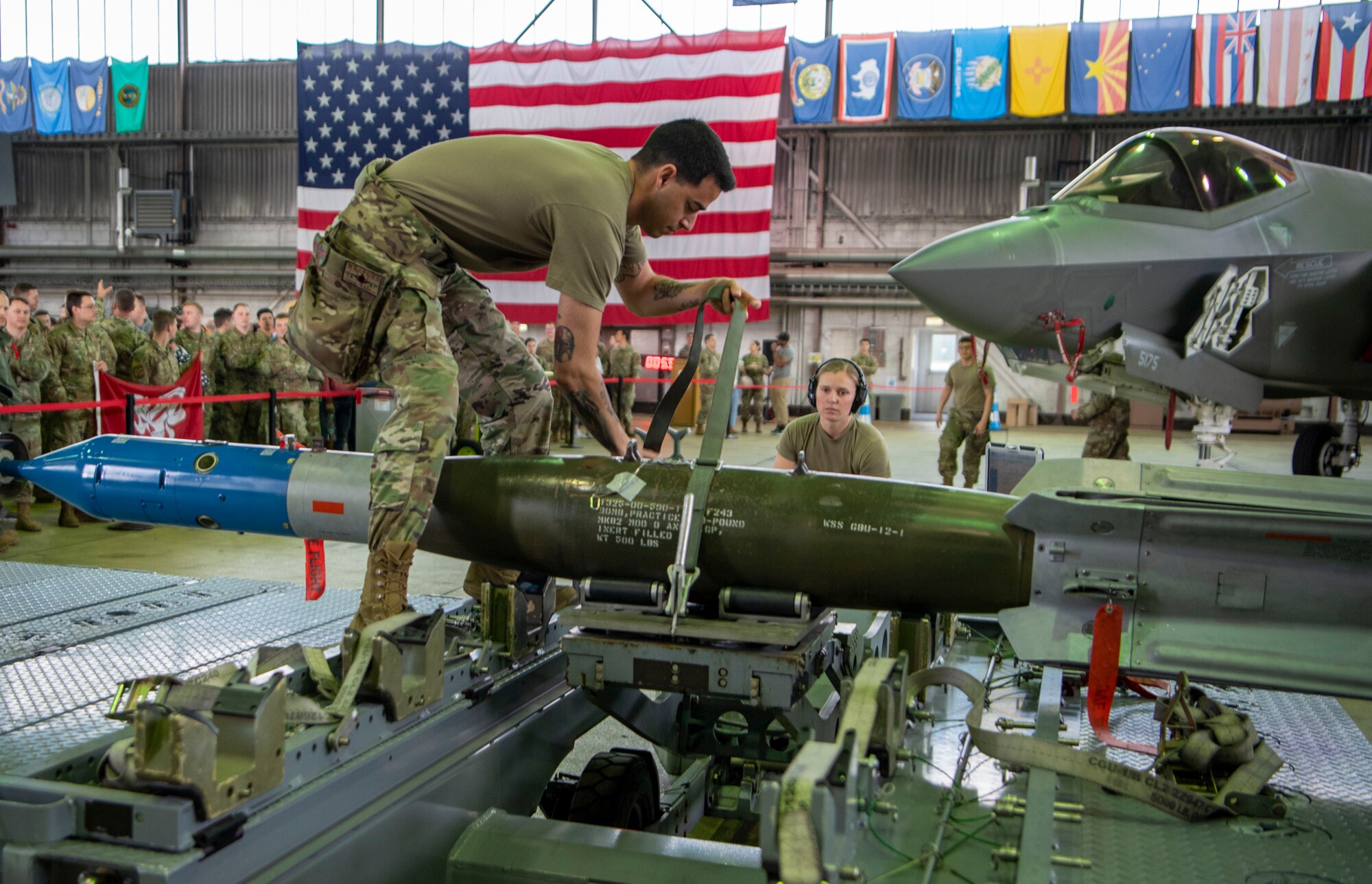 Staff Sgt. Jake Charloff, 34th Fighter Generation Squadron weapons crew team chief, prepares to load a GBU-12 paramount  onto an F-35A Lightning II fifth-generation fighter aircraft during the Weapons Load Crew of the Quarter competition at Spangdahlem Air Base, Germany, April 14, 2022. Prior to the competition, load crews prepared composite tool kits for an inspection and completed a written examination, both elements were calculated into their final score. (U.S. Air Force photo by Airman 1st Class Jessica Sanchez-Chen)
