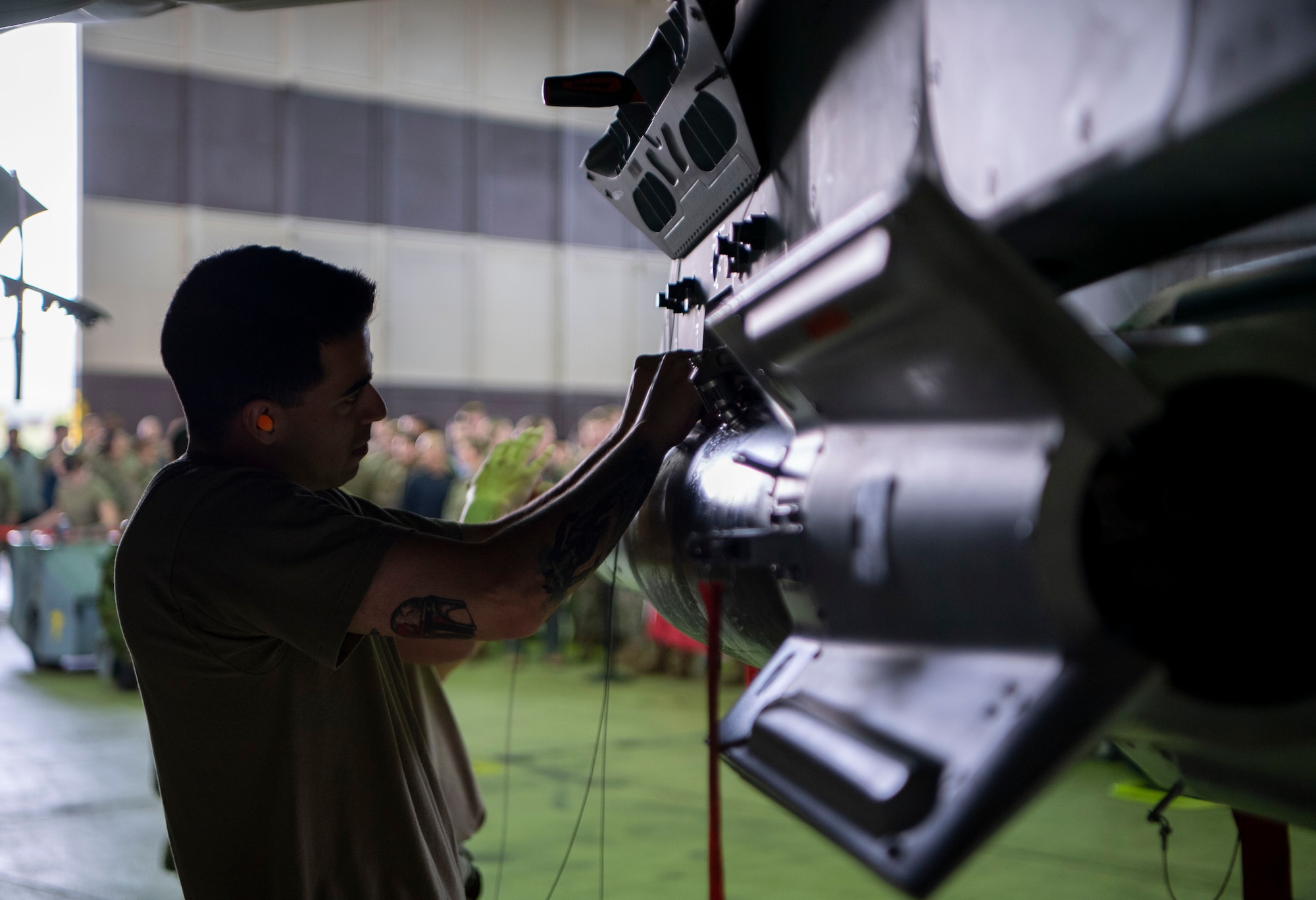 Staff Sgt. Jake Charloff, 34th Fighter Generation Squadron weapons crew team chief, secures a GBU-12 paramount onto an F-35A Lightning II fifth-generation fighter aircraft during the Weapons Load Crew of the Quarter competition at Spangdahlem Air Base, Germany, April 14, 2022. The crews were tasked to load an AIM-9X and an GBU-12 paramount. (U.S. Air Force photo by Airman 1st Class Jessica Sanchez-Chen)