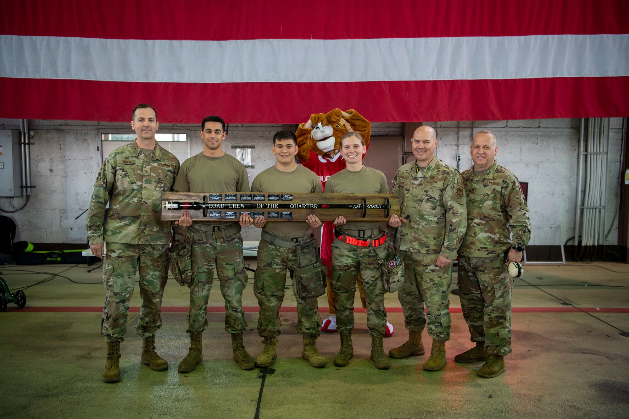 Members of the 34th Fighter Generation Squadron pose for a photo after winning the Weapons Load Crew of the Quarter competition against Saber Nation’s F-16 Fighting Falcon fighter aircraft weapons load crew at Spangdahlem Air Base, Germany, April 14, 2022. The crews loaded an AIM-9X and a GBU-12 paramount while being evaluated on safety, reliability, technical proficiency and time. (U.S. Air Force photo by Airman 1st Class Jessica Sanchez-Chen)