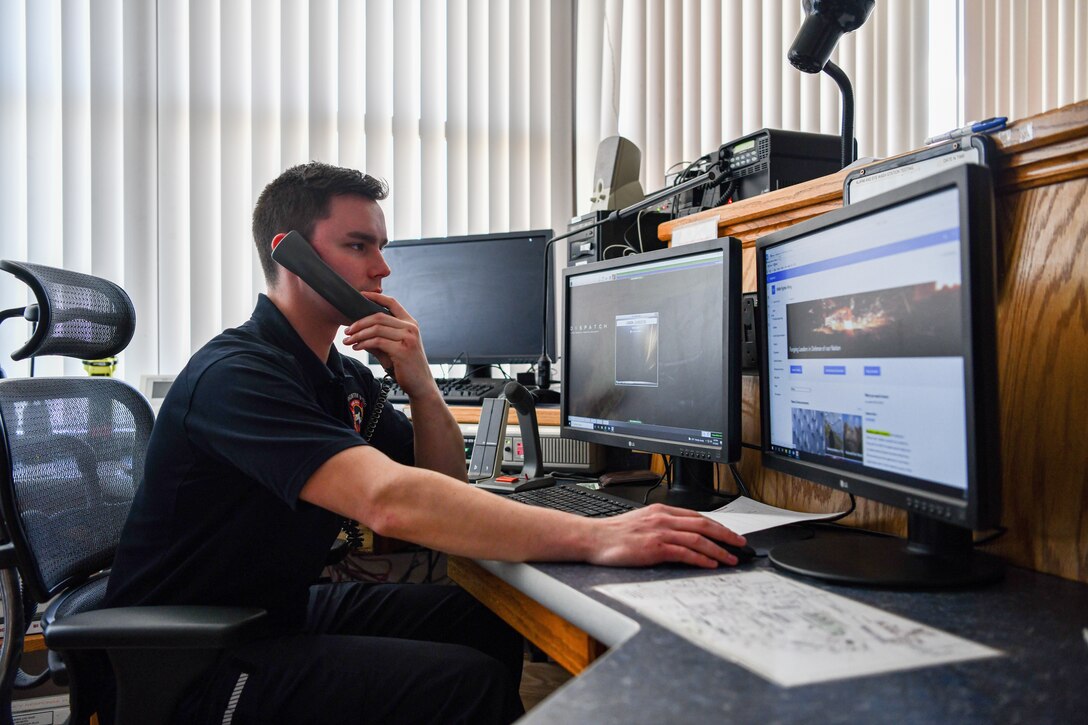 Staff Sgt. Austin Herman, 104th Civil Engineering Squadron firefighter, works in the fire alarm communications center April 12, 2022, at Barnes Air National Guard Base, Massachusetts. The fire alarm communications center is staffed by a minimum of one firefighter 24 hours a day, seven days a week. The crews want to make sure members on base know that dialing 911 from a base phone will contact them, while calling 911 from a personal phone will contact the municipal dispatch off base. By calling from a base phone, members can ensure a quicker response to on base emergencies. (U.S. Air National Guard photo by Randy Burlingame)