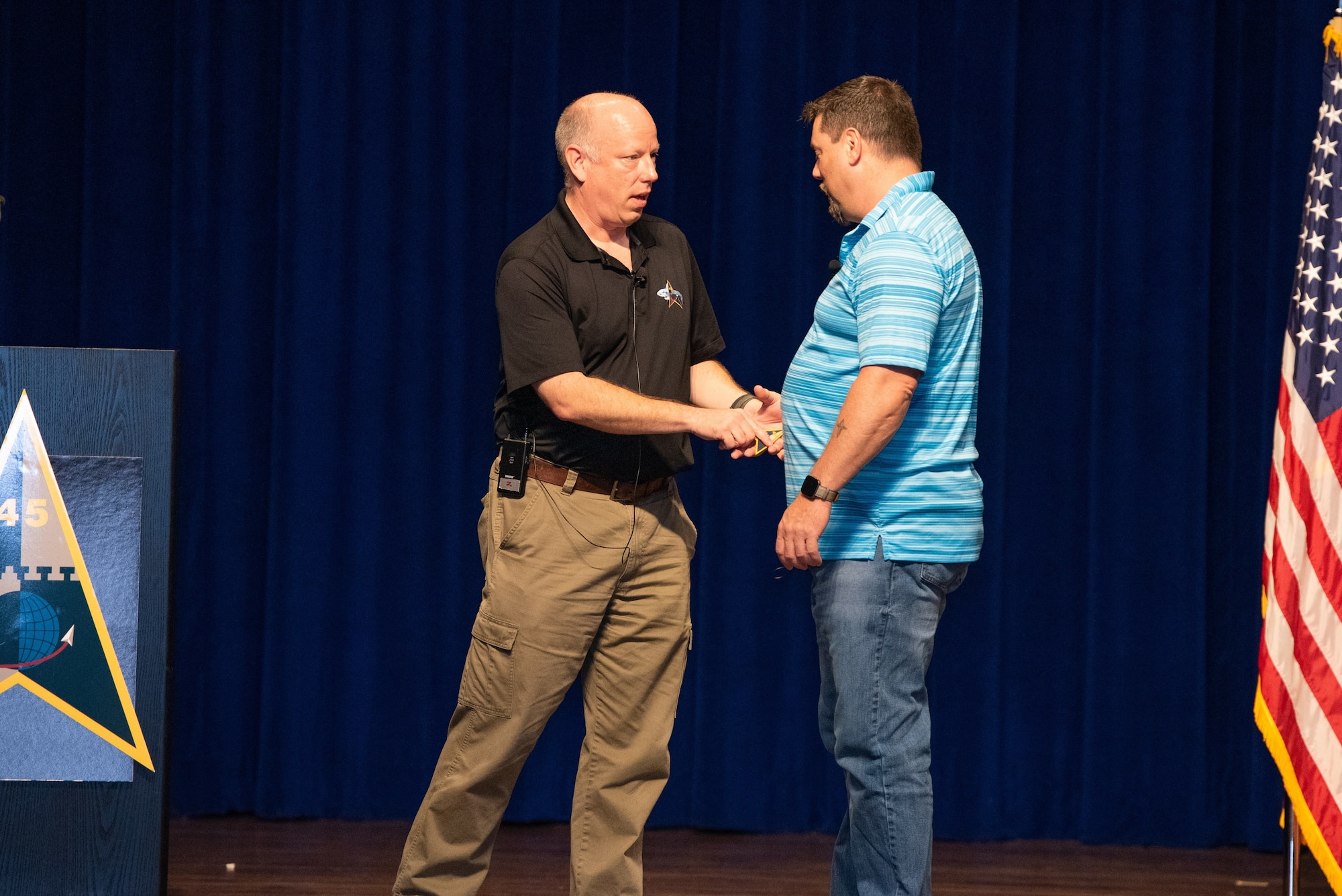 U.S. Space Force Brig. Gen. Stephen Purdy, left, Space Launch Delta 45 commander, presents an SLD 45 patch to Heath Phillips, a U.S. Navy veteran and a sexual assault survivor, April 15, 2022, during Resilience Day at Patrick Space Force Base, Florida. Phillips was one of two guest speakers at the event and spoke about the importance of personal resilience and looking out for one another. (U.S. Space Force photo by Amanda Inman)