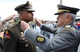 Maj. Gen. William L. Thigpen is presented with the Brazilian Order of Military Merit medal by the Minister General of the Brazilian Army Gen. Luis Carlos Gomes Mattos during the Brazilian Army Day, April 19, celebrating the Army's 374th birthday. The Order of Merit is the highest honorary distinction of the Brazilian Army.