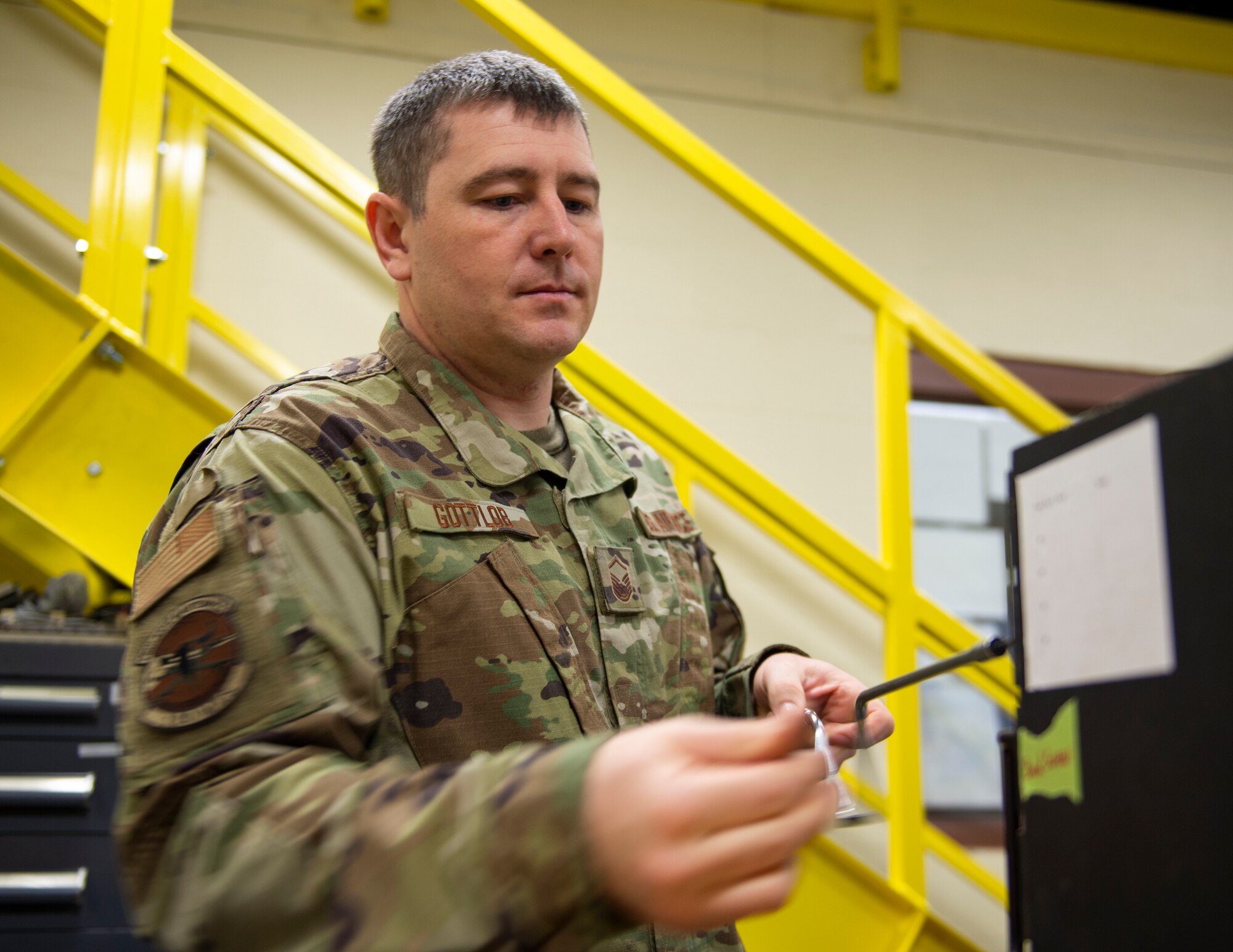 U.S. Air Force Master Sgt. Keith Gottlob, 120th Maintenance Squadron, removes screws from a lightning control unit in St. Paul, Minn., April 7, 2022.