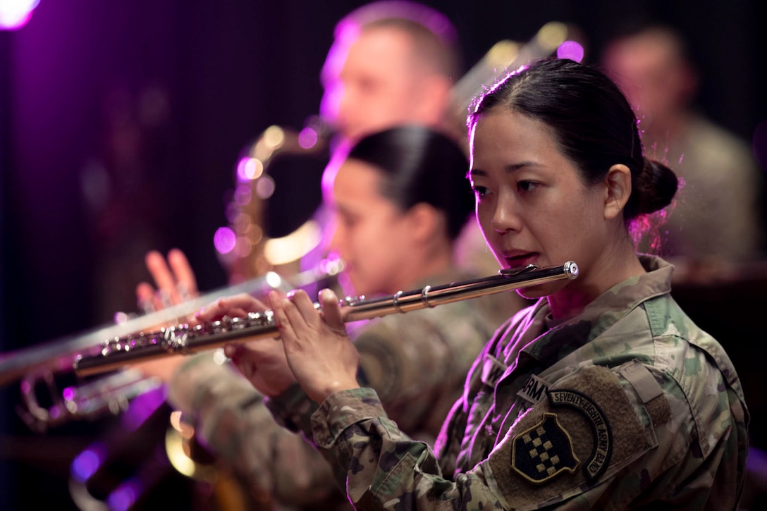 A soldier plays an instrument.