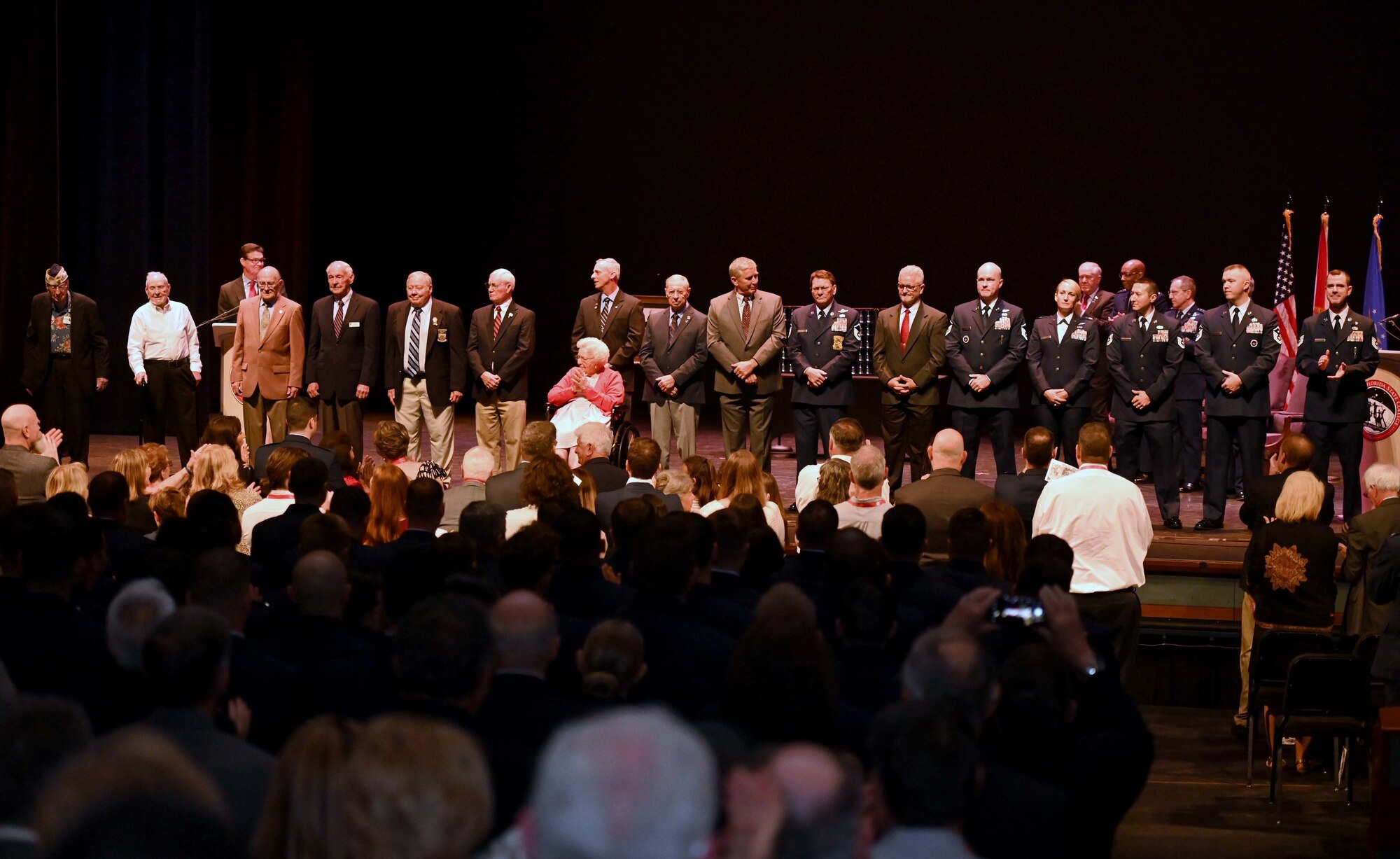 Sixteen local active-duty service members and veterans receive a standing ovation during the Doolittle Raider Goblet Ceremony at the Mattie Kelly Arts Center at Northwest Florida State College, Niceville, Florida, April 18, 2022. They were honored to represent the legacy of each of the 16 Doolittle crews and the contributions of an untold number of fellow Airmen to recognize the 75th Anniversary of the Air Force. (U.S. Air Force photo by Staff Sgt. Brandon Esau)