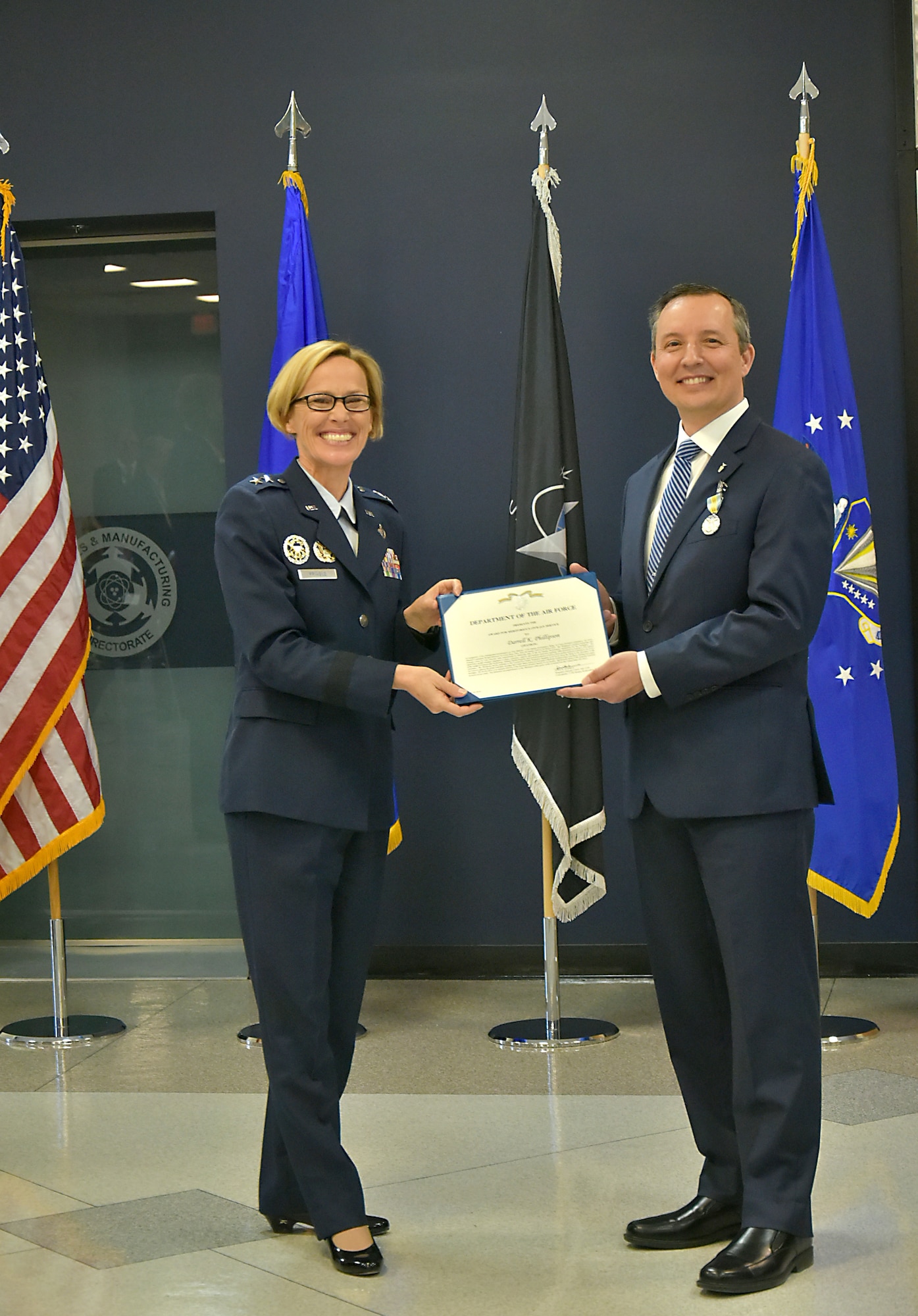 Maj. Gen. Heather Pringle presents Mr. Darrell Phillipson with the Meritorious Civilian Service Award.