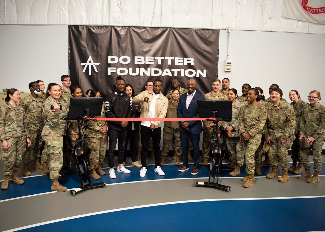 Cycling instructor Alex Toussaint cuts a ceremonial ribbon signifying the donation of two pieces of exercise equipment to the Tactical Fitness Center at Joint Base Andrews, Md., April 19, 2022.