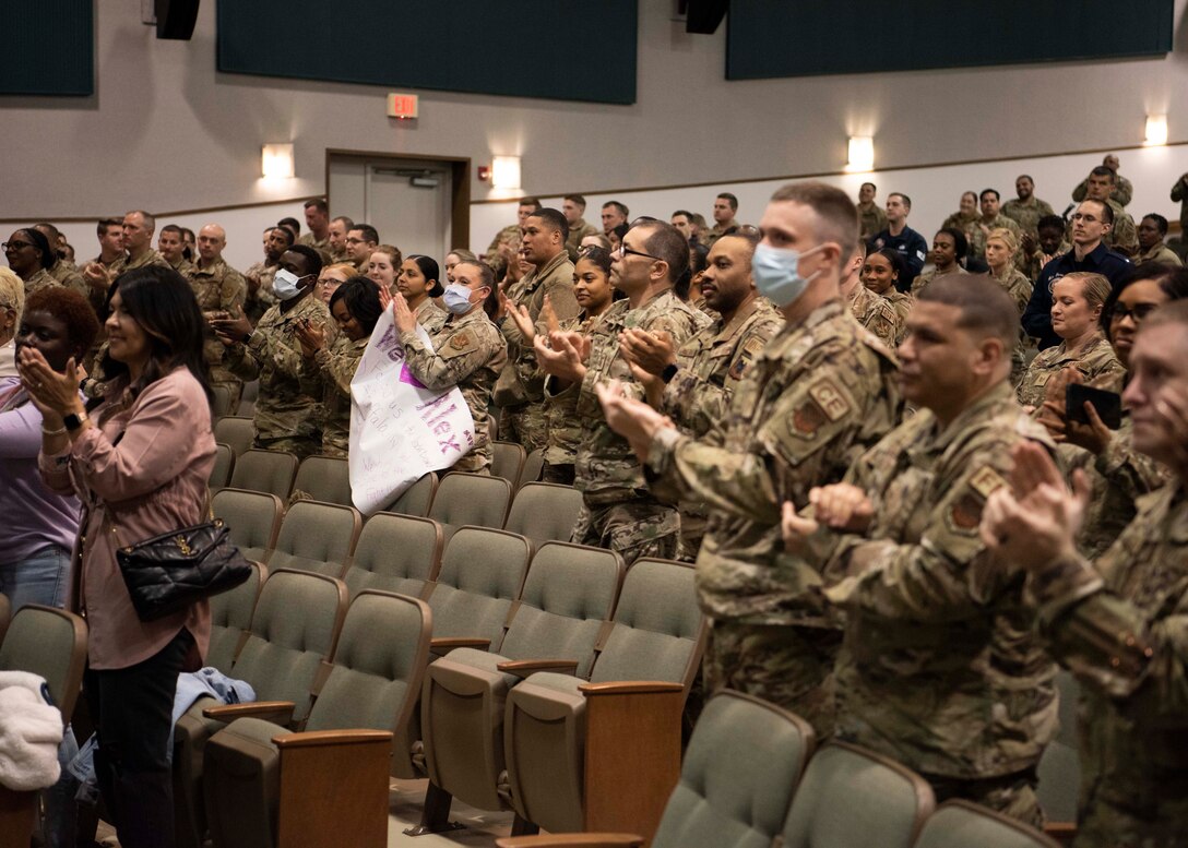 Audience members applaud retired Chief Master Sgt. of the Air Force Kaleth O. Wright and cycling instructor Alex Toussaint after they spoke about mental health and wellness topics at Joint Base Andrews, Md., April 19, 2022.
