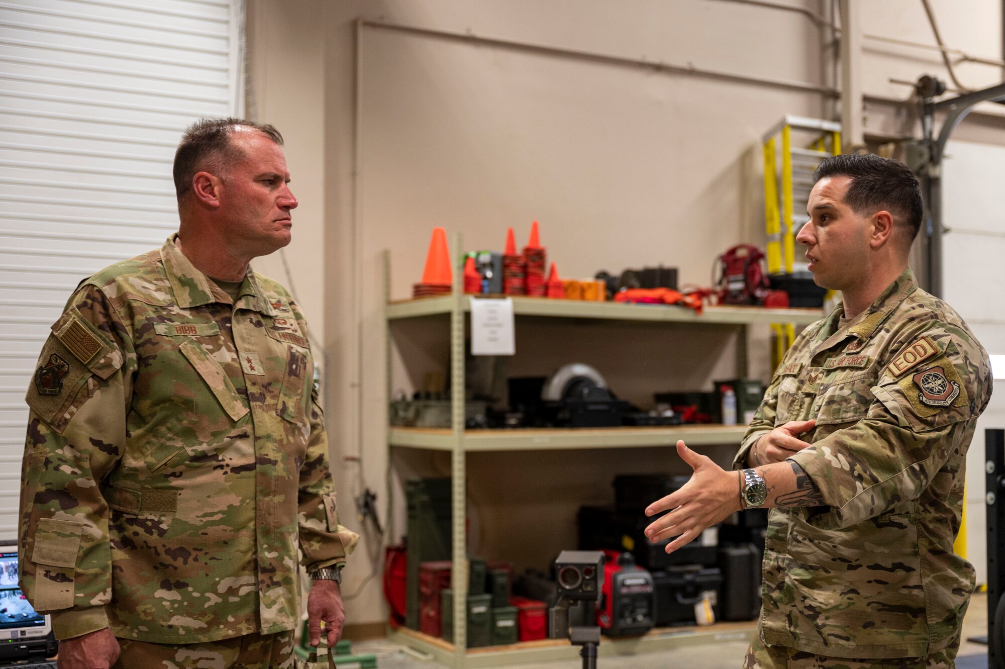 Maj. Gen. Kenneth Bibb, 18th Air Force commander, left, receives a brief from Staff Sgt. Jose Delgado, 19th Civil Engineer Squadron explosive ordnance technician, right, during a visit to Little Rock Air Force Base