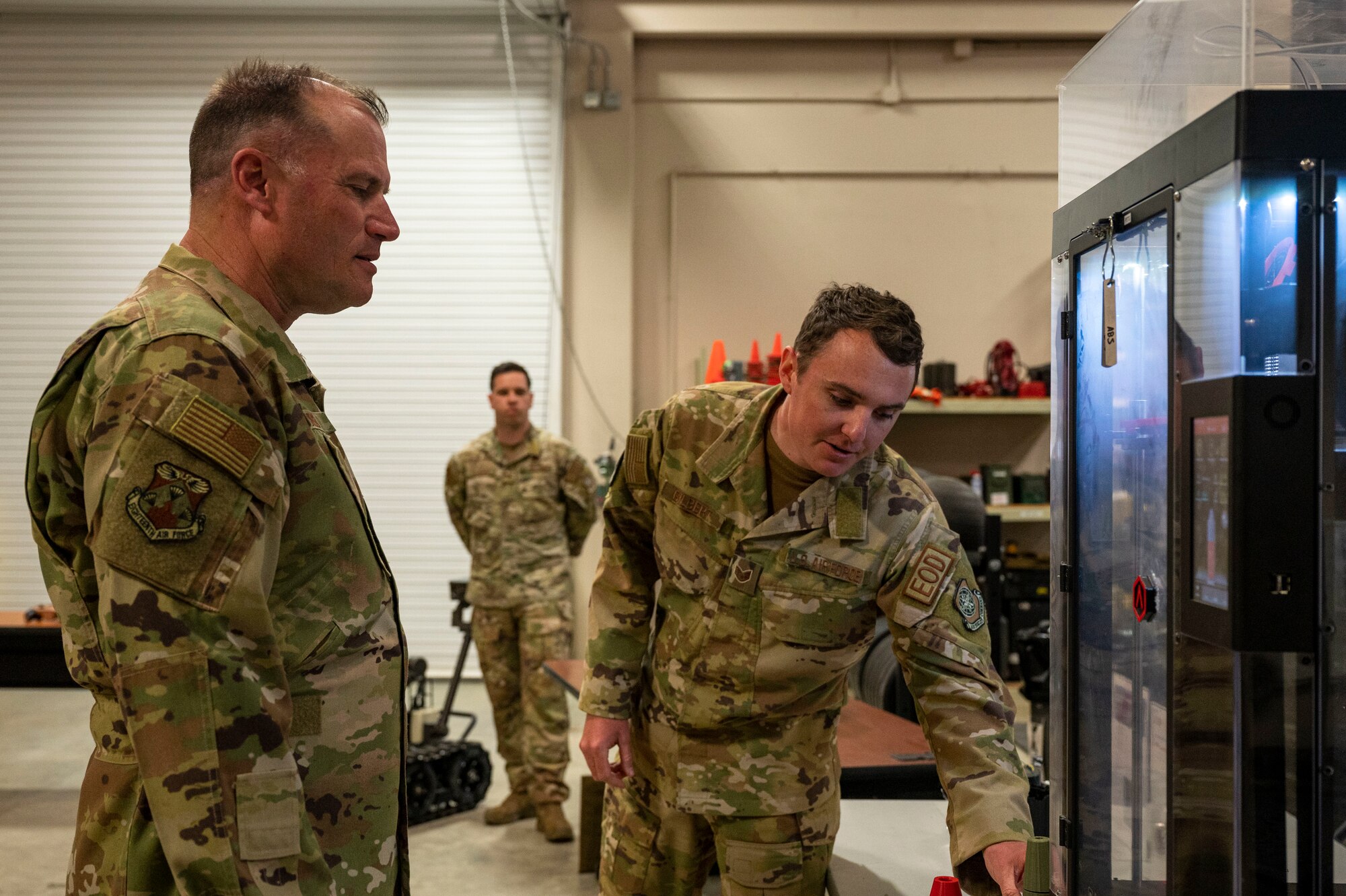 Maj. Gen. Kenneth Bibb, 18th Air Force commander, observes a 3D printer belonging to the 19th Civil Engineer Squadron explosive ordnance disposal flight during a visit to Little Rock Air Force Base