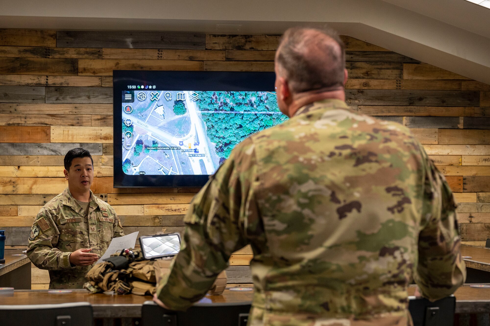 Tech. Sgt. Brandon Tran, 19th Civil Engineer Squadron explosive ordnance technician, left, briefs Maj. Gen. Kenneth Bibb, 18th Air Force commander, right, during a visit to Little Rock Air Force Base
