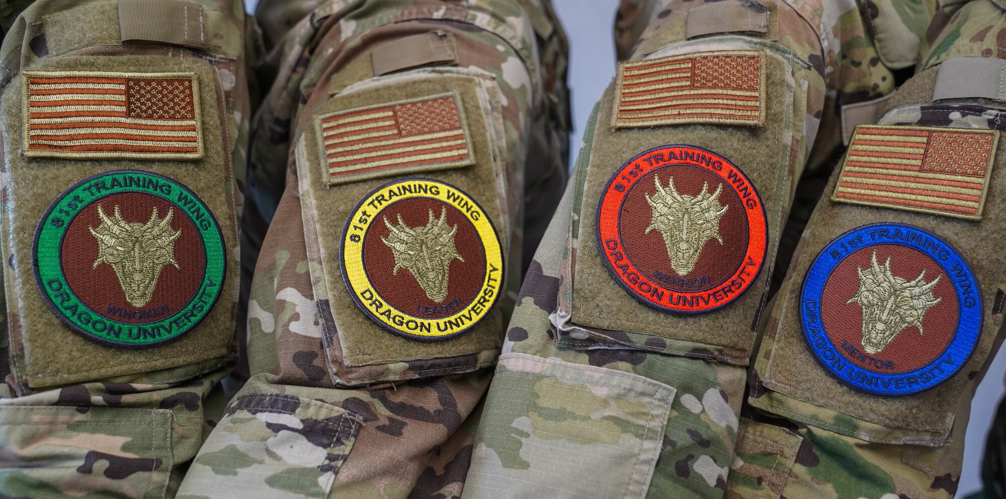 U.S. Air Force Airmen from the 81st Training Wing model Dragon University morale patches at Keesler Air Force Base, Mississippi, April 13, 2022. Dragon University is Keesler’s new professional and personal development program. (U.S. Air Force Photo by Airman 1st Class Elizabeth Davis)