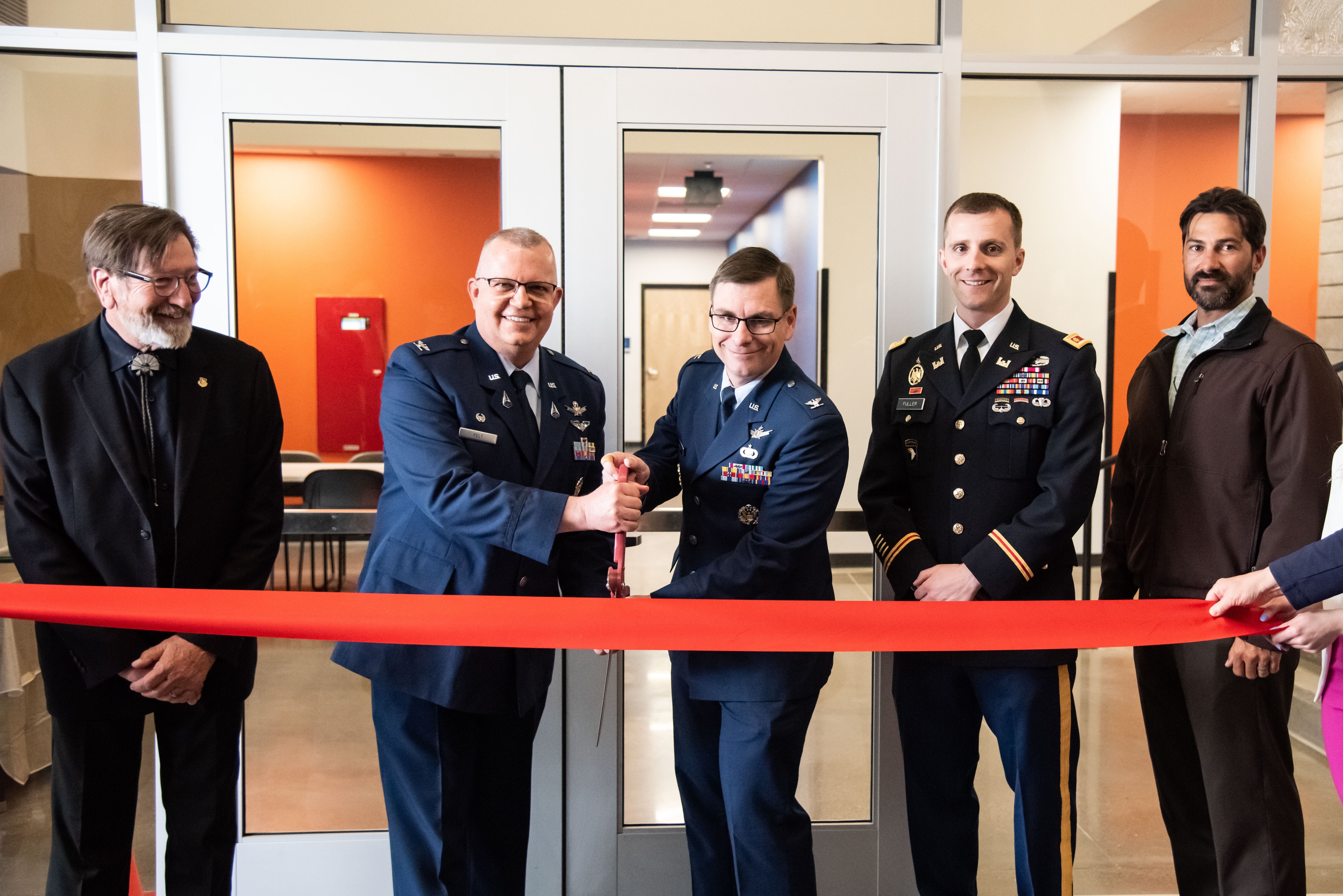 The Air Force Research Laboratory, or AFRL, Space Vehicles Directorate held a ribbon cutting ceremony for its newest space facility, the Rapid Architecture Prototyping and Integration Development, or RAPID, laboratory, at Kirtland Air Force Base, New Mexico, April 12, 2022, with Col. Eric Felt, director, AFRL Space Vehicles Directorate, as the presiding official. Joining Felt in the ribbon cutting are (from left): Bradley Rieck, AFRL senior engineer facility project lead; Felt; Col. Jon Luminati, AFRL Integrated Experiments and Evaluation Division chief; Maj. Brett Fuller, U.S. Army Corps of Engineers, or USACE, Albuquerque District deputy commander; and Filemon Gallegos, USACE project manager.