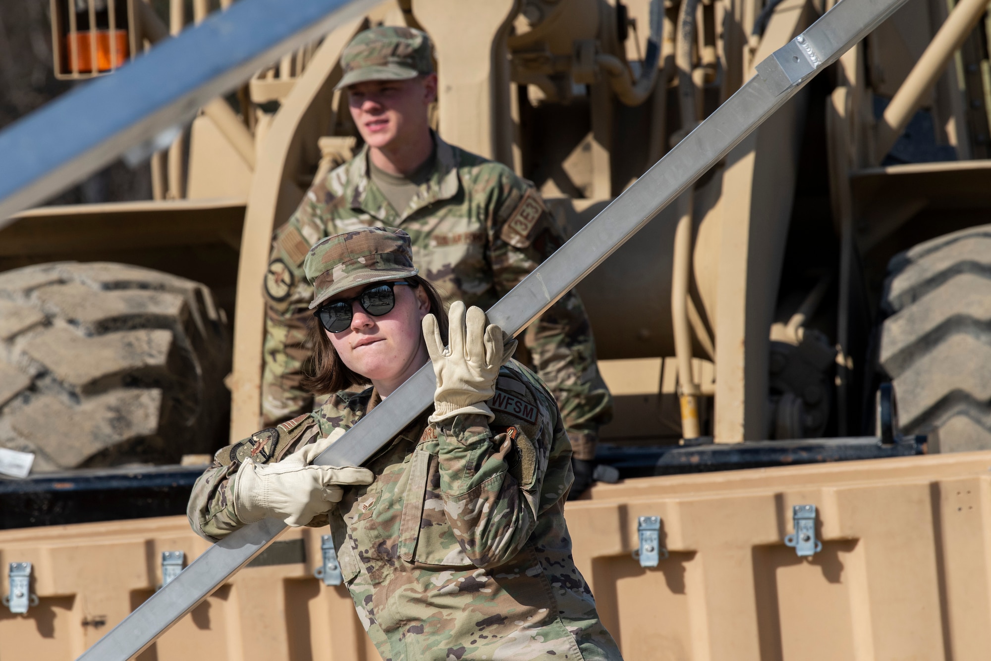 A photo of a woman carrying a beam