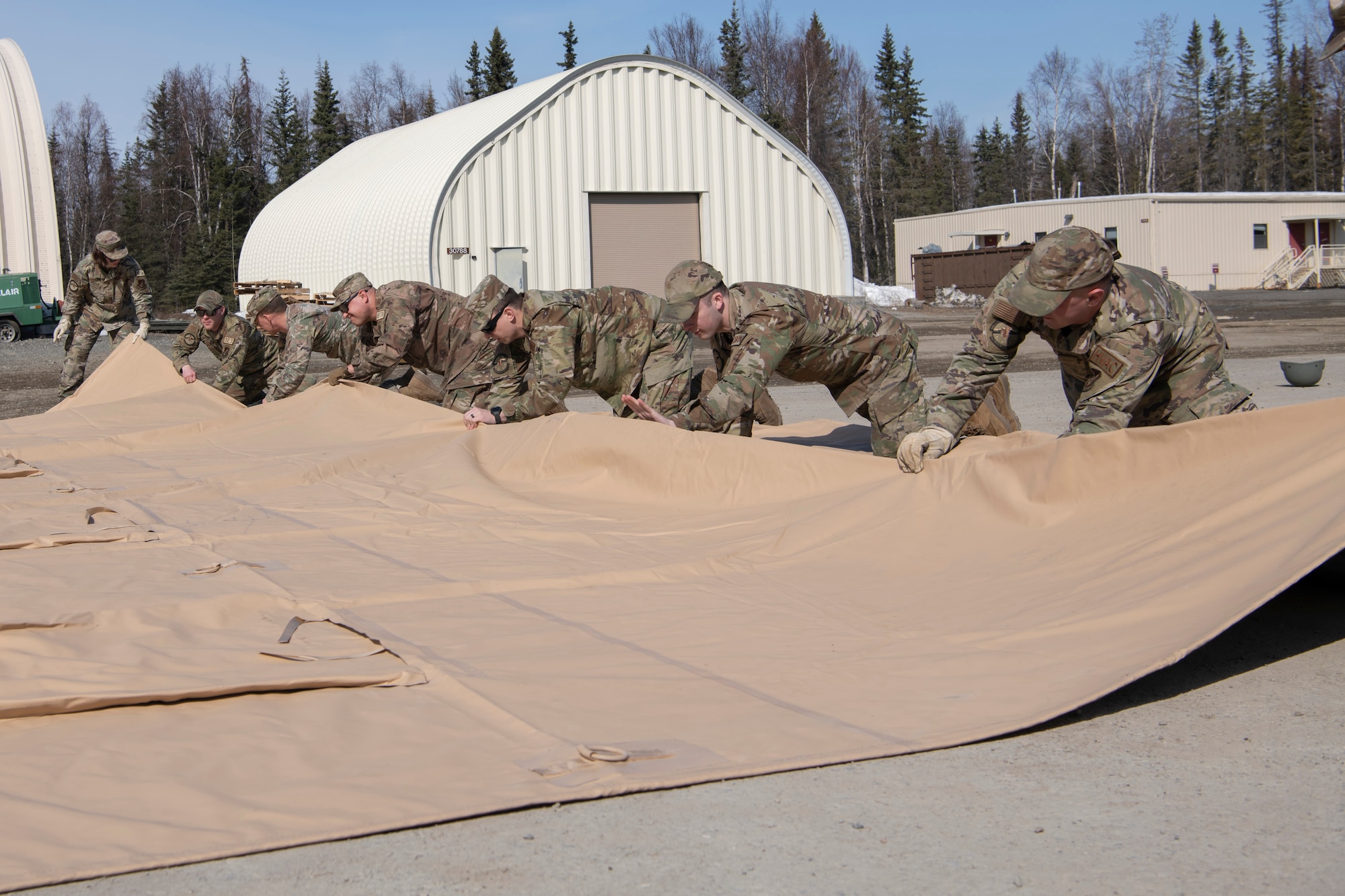 A photo of men folding a tarp