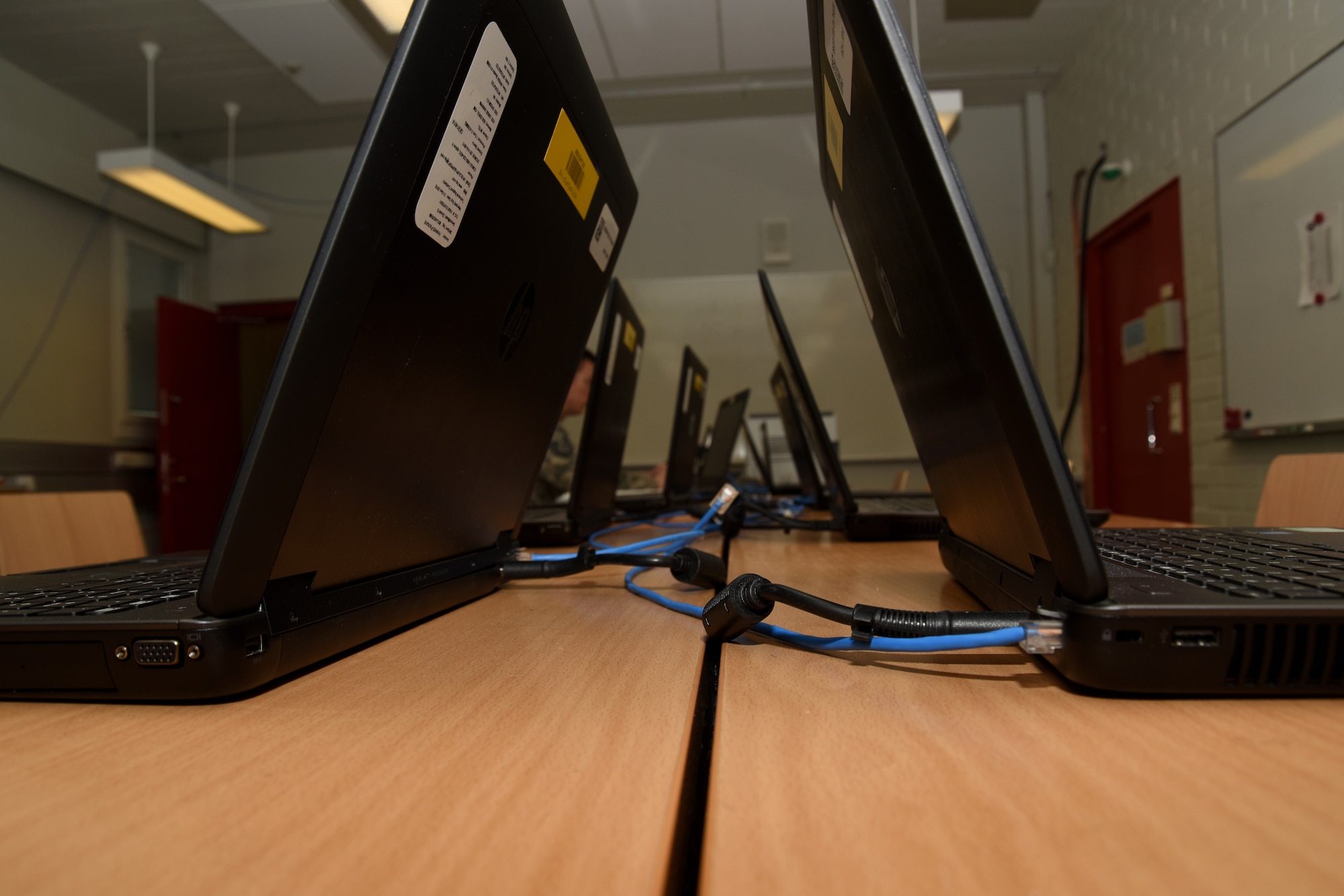 NIPR computers sit ready for use on a table.