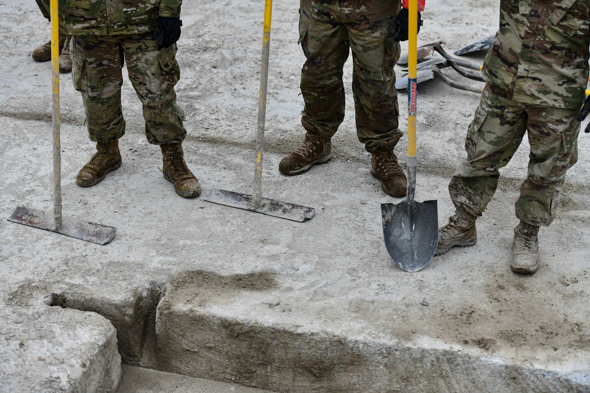 Airmen fill a crater with concrete.