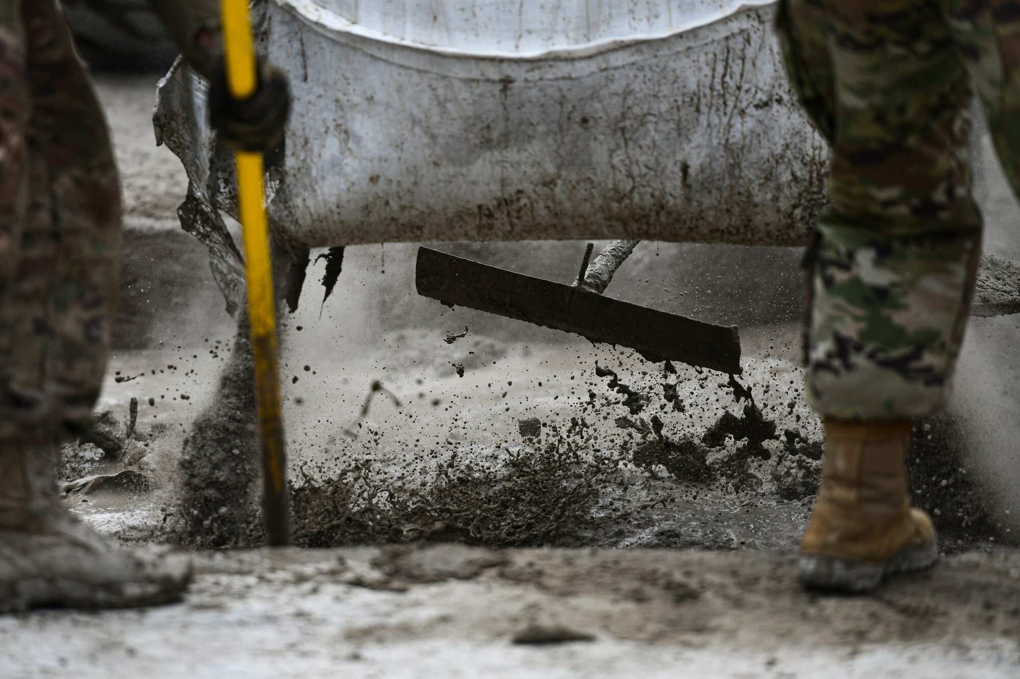 Airmen mix concrete.