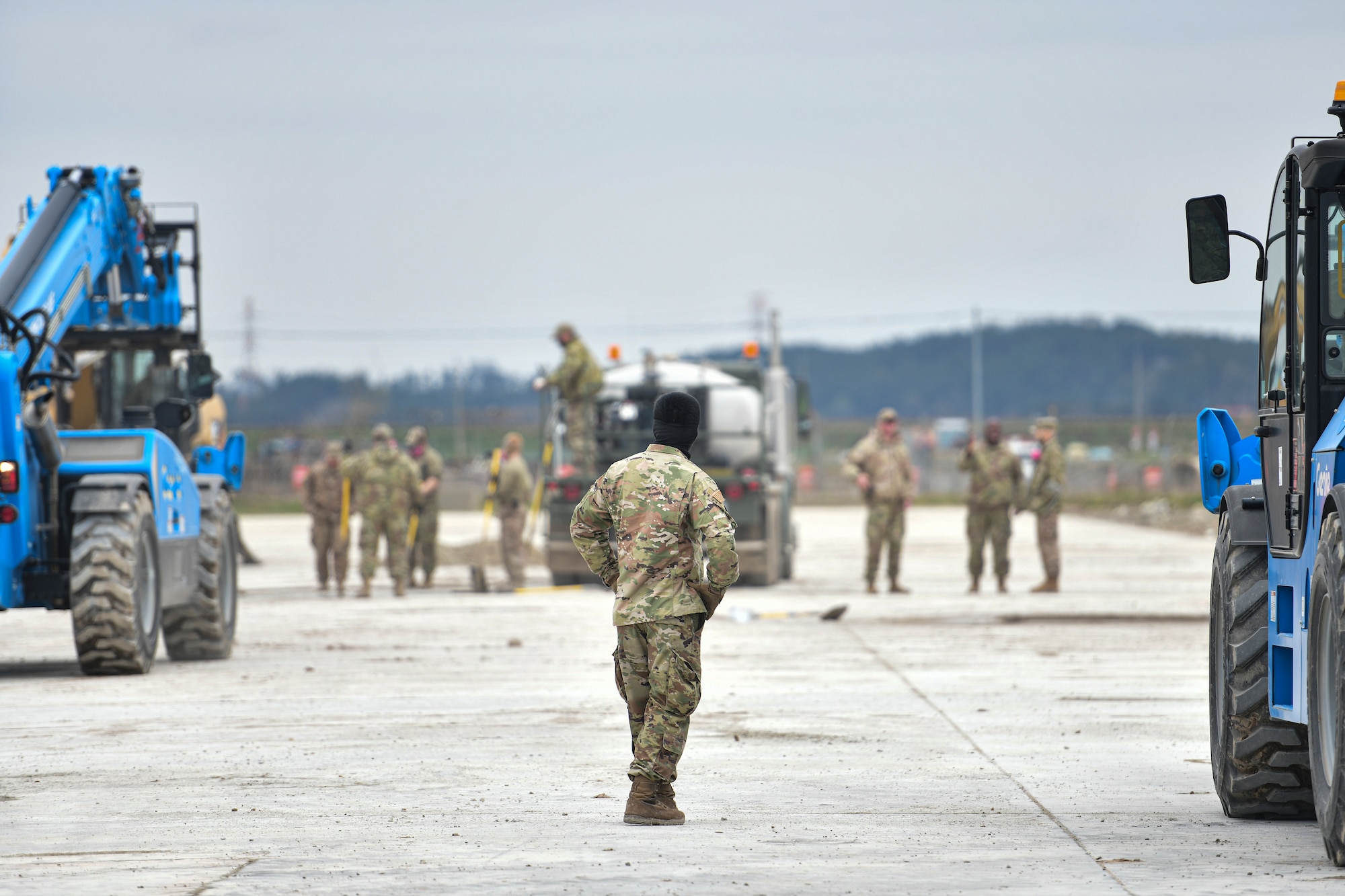 An Airman watches runway repair training.