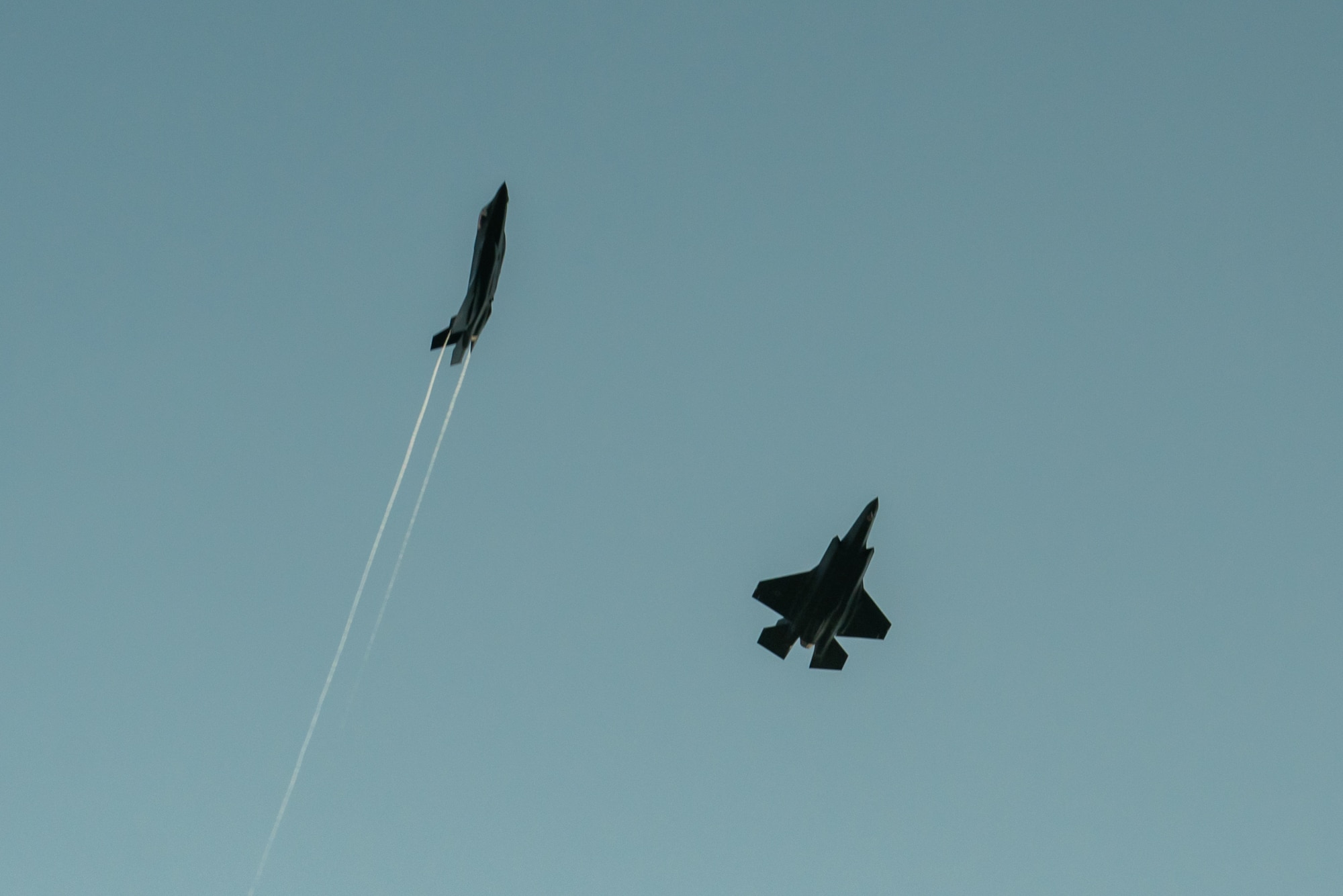 Photo of two fighter jets flying overhead