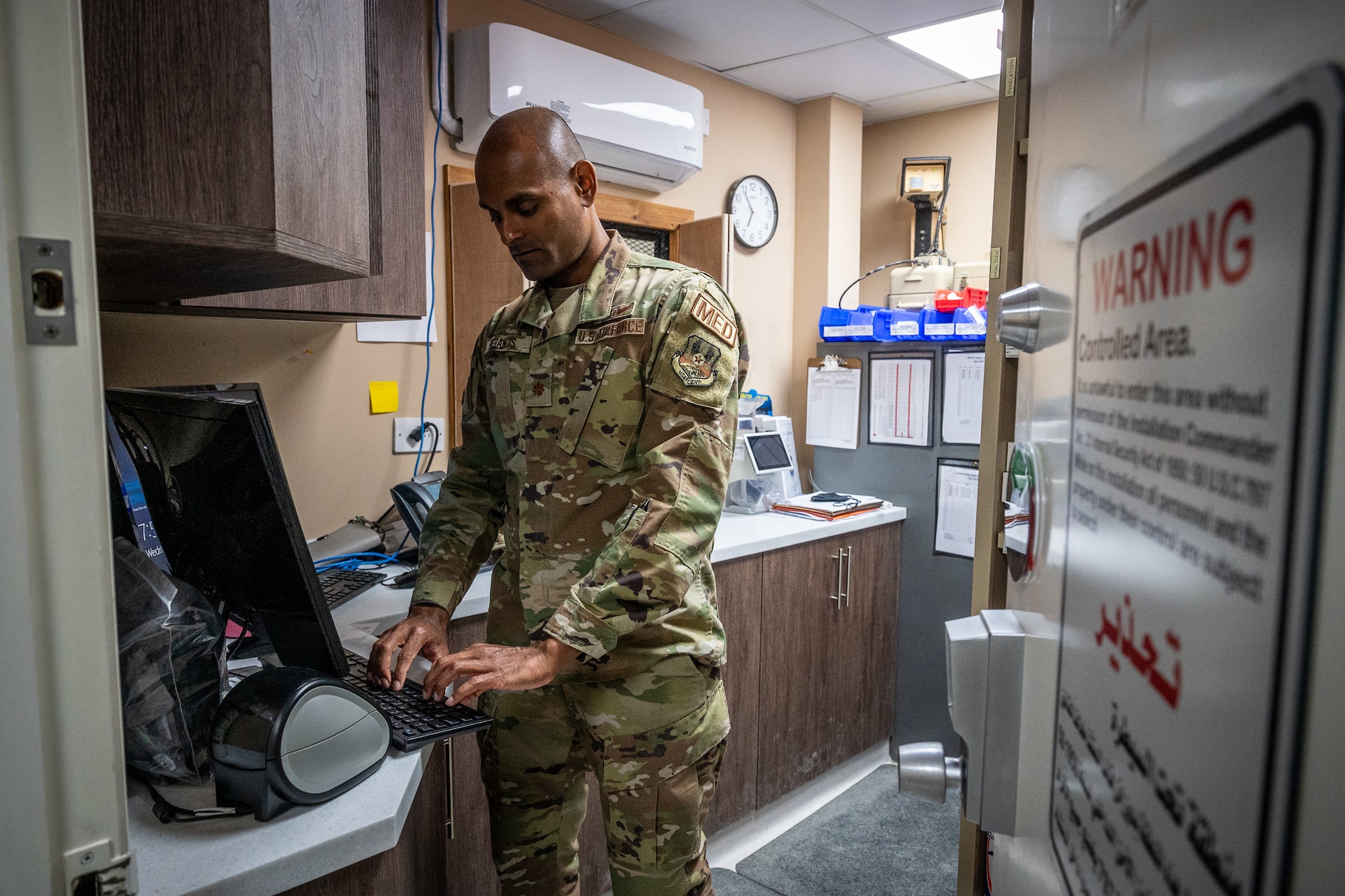 U.S. Air Force Maj. Sunil Francis, 332d Expeditionary Medical Group chief nurse, logs onto a computer located in the clinic pharmacy to check for prescriptions in the queue to be filled at an undisclosed location in Southwest Asia, April 6, 2022. Francis is a multi-capable Airman because he supports the pharmacist, Capt. Asia Sanders, 332d EMDG chief of ancillary services, as the on-call pharmacist. (U.S. Air Force photo by Master Sgt. Christopher Parr)