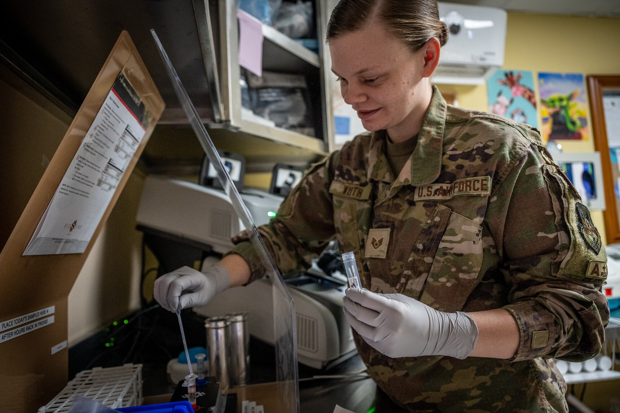 U.S. Air Force Staff Sgt. Kiersten Wirth, 332d Expeditionary Medical Group medical technician, processes a COVID-19 test in the 332d EMDG laboratory at an undisclosed location in Southwest Asia, April 6, 2022. Wirth helps in the lab and with X-rays as a multi-capable Airman within the 332d EMDG. (U.S. Air Force photo by Master Sgt. Christopher Parr)