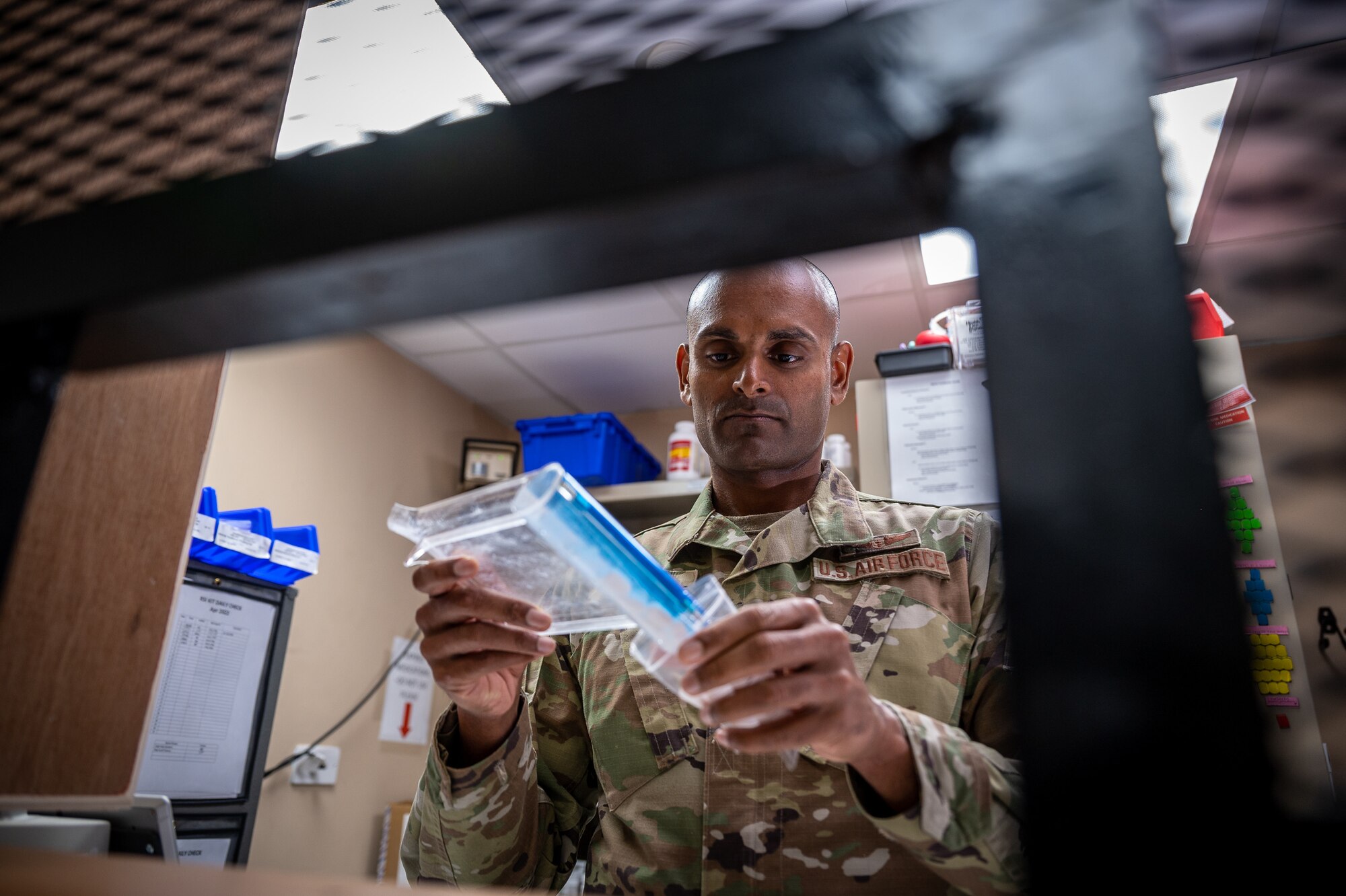 U.S. Air Force Maj. Sunil Francis, 332d Expeditionary Medical Group chief nurse, fills a prescription at an undisclosed location in Southwest Asia, April 6, 2022. Francis is a multi-capable Airman because he supports the pharmacist, Capt. Asia Sanders, 332d EMDG chief of ancillary services, as the on-call pharmacist. (U.S. Air Force photo by Master Sgt. Christopher Parr)