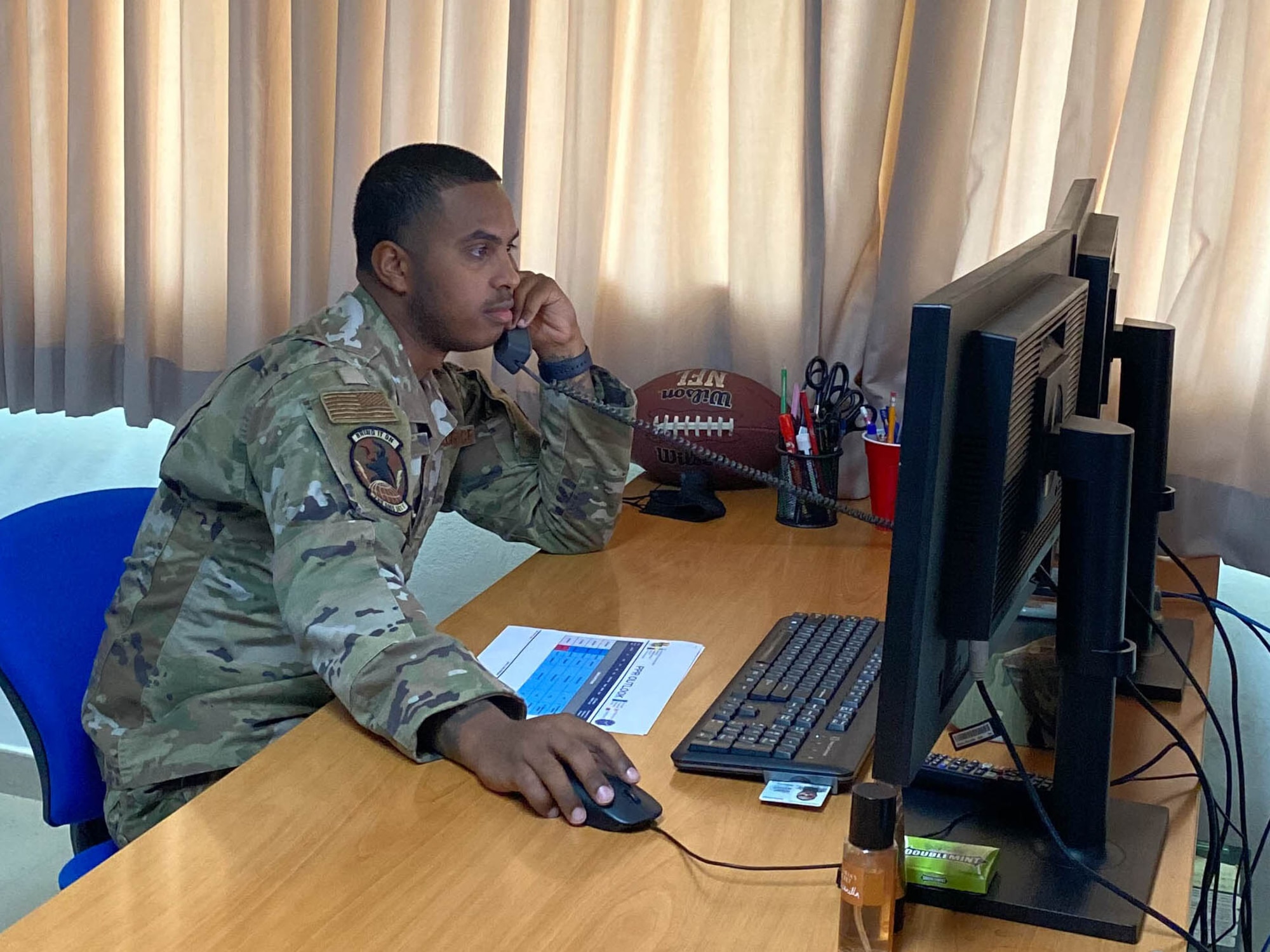 An Airman works on his computer