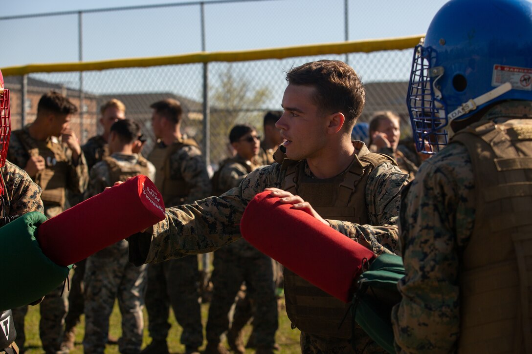 U.S. Marine Corps Cpl. Aaron Wells, Martial Arts Instructor (MAI) Course student, practices coaching pugil sticks at Ellis Field, Courthouse Bay on Marine Corps Base Camp Lejeune, April 8, 2022. The MAI course is a three-week course designed to prepare Marines to teach and instruct the fundamentals of hand-to-hand combat. (U.S. Marine Corps photo by Cpl. Makayla Elizalde)